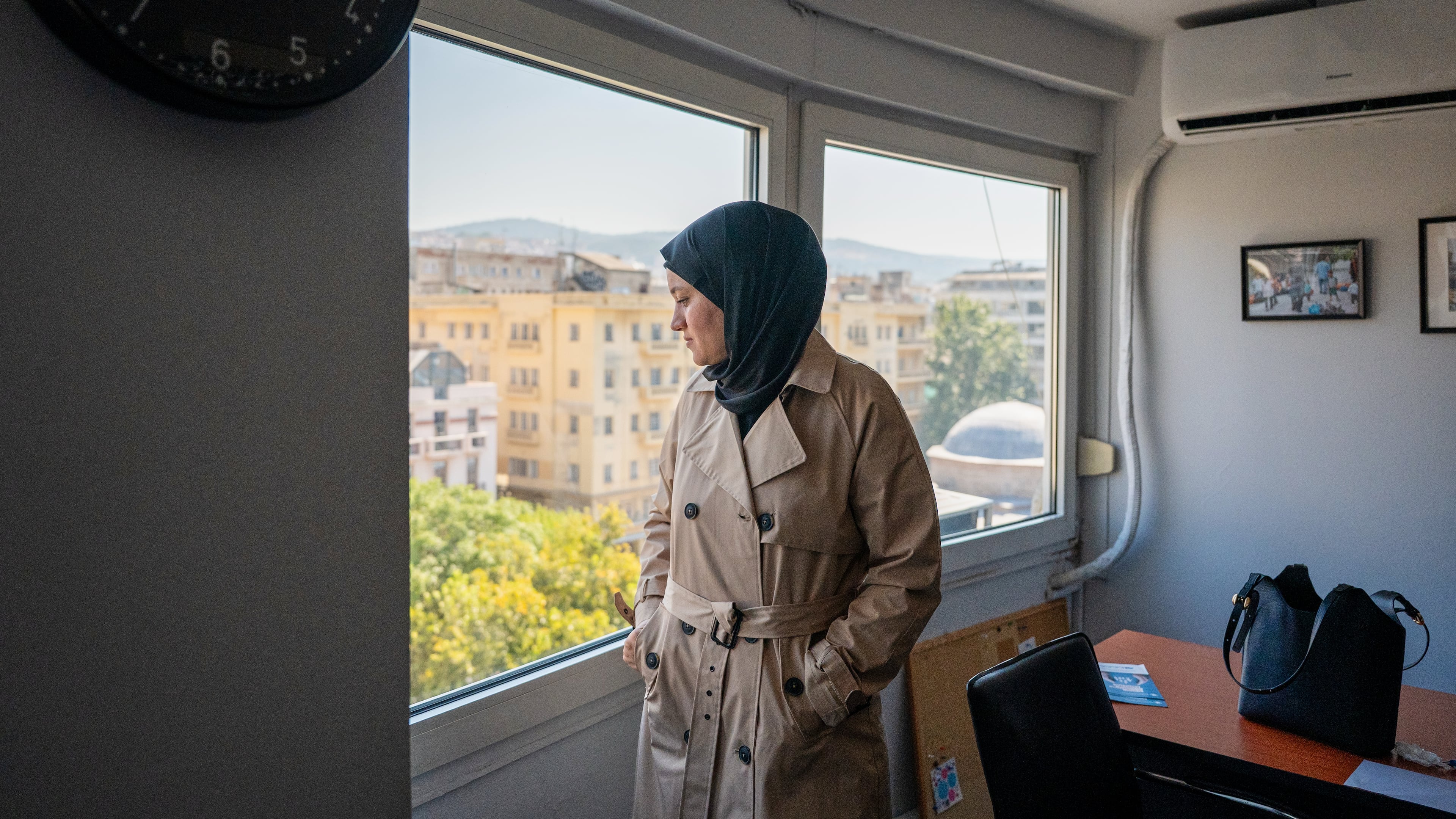 Wesam Hamada, the mother of Hind Rajab, a Palestinian girl who was killed in Gaza City in January 2024 after the car she was in with relatives came under Israeli fire, looks out a window at an office building at an undisclosed location, Friday, Aug. 21, 2026. (AP Photo/Giannis Papanikos) ADDITION: Location removed at the subject's request.