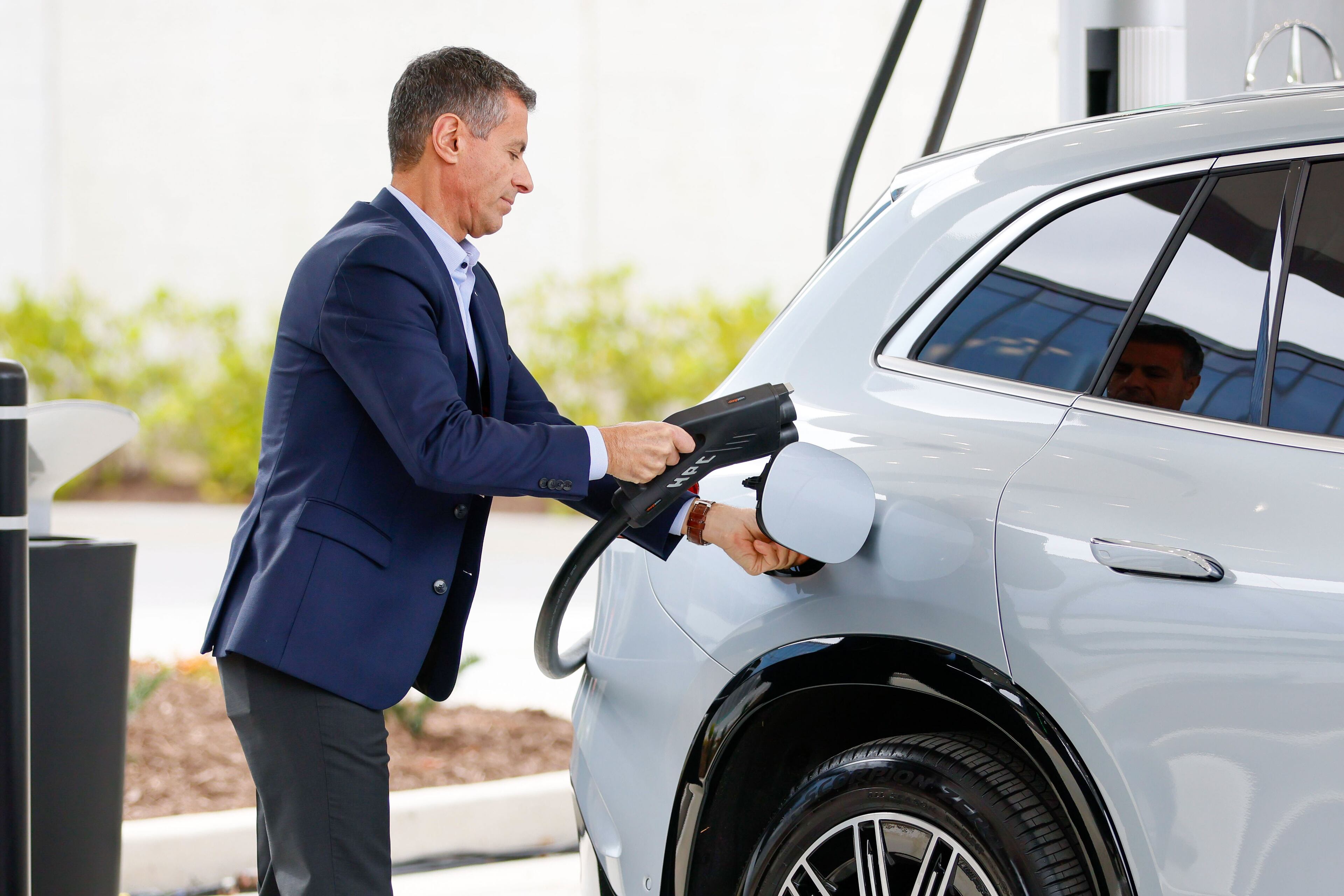 Dimitris Psillakis, President & CEO of Mercedes-Benz USA, is seen plugging the electric charger into a car during the unveiling of the first-of-its-kind EV fast-charging hub at the company’s U.S. headquarters, kicking off an effort to install 2,000 charges worldwide by the end of 2024.
Miguel Martinez /miguel.martinezjimenez@ajc.com