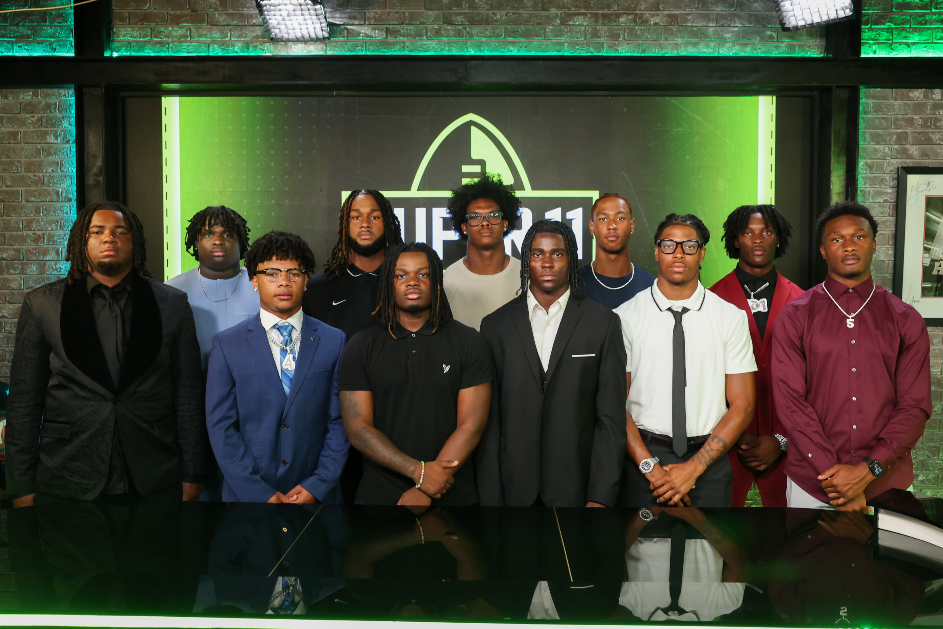 The Super 11 Class of 2026 pose for a portrait at the Super 11 reveal show at Score ATL in Roswell on Aug. 3, 2026. (Arvin Temkar/AJC)