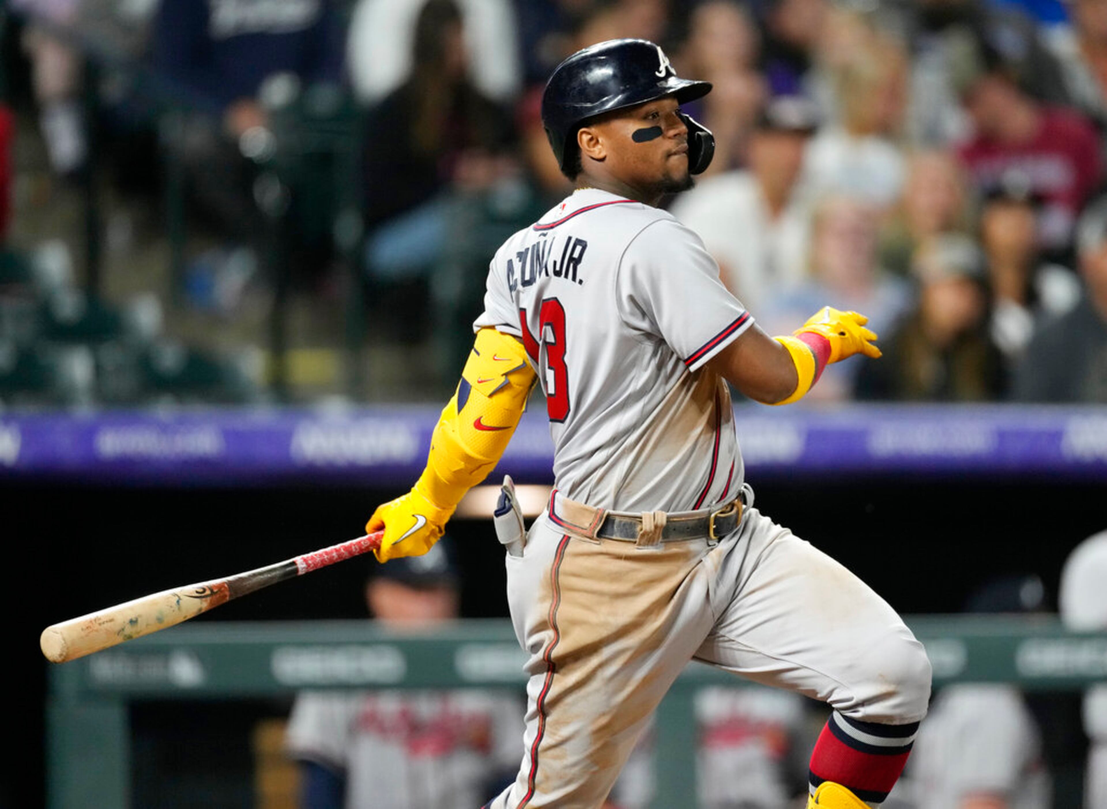 Atlanta Braves' Ronald Acuna Jr. watches his RBI single off Colorado Rockies relief pitcher Ty Blach during the seventh inning of a baseball game Thursday, June 2, 2022, in Denver. (AP Photo/David Zalubowski)