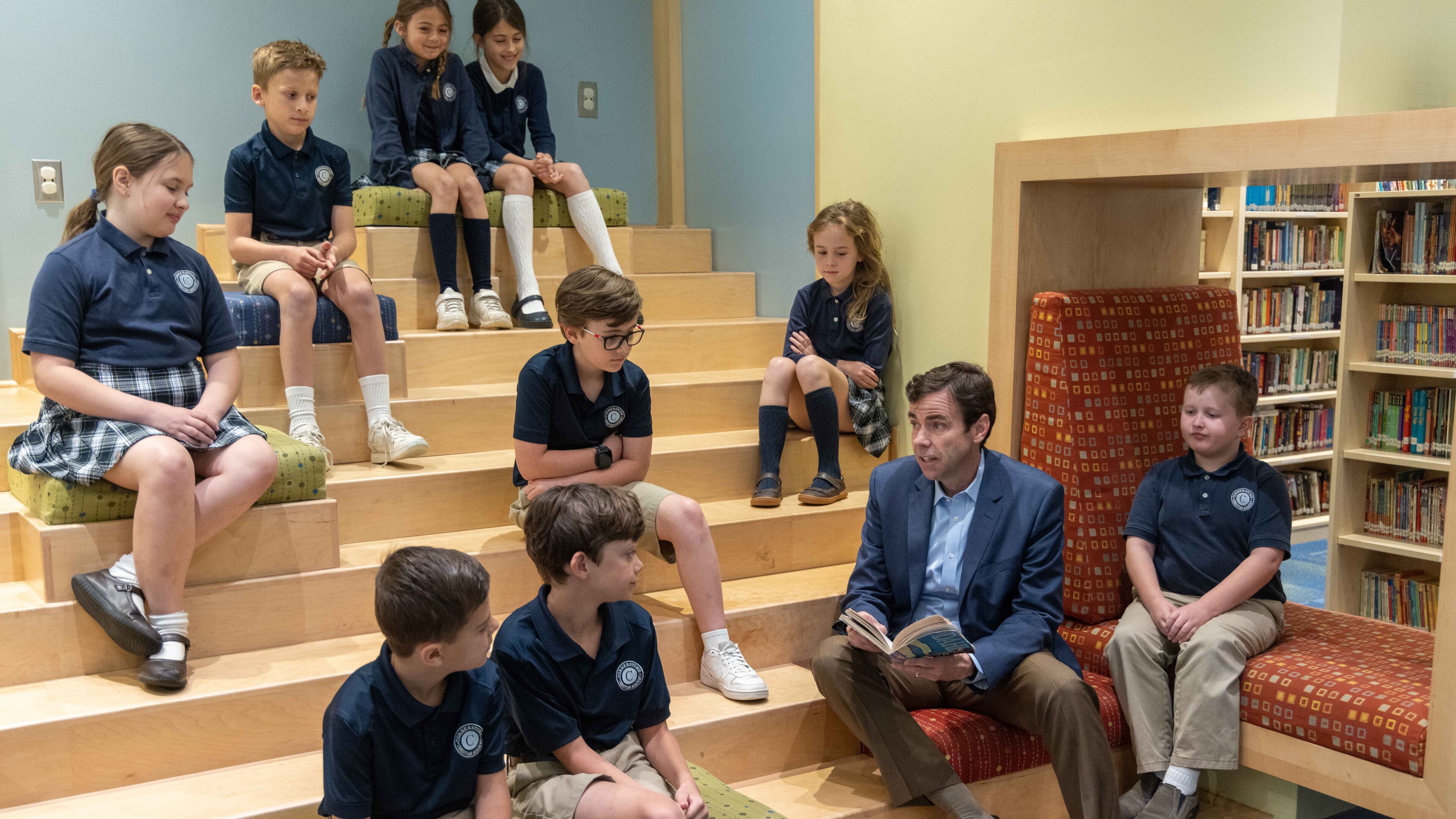 Cornerstone Academy Headmaster Colin Creel (second from right) reads to a class of students the library. For the Top Workplace small sized business. PHIL SKINNER FOR THE ATLANTA JOURNAL-CONSTITUTION