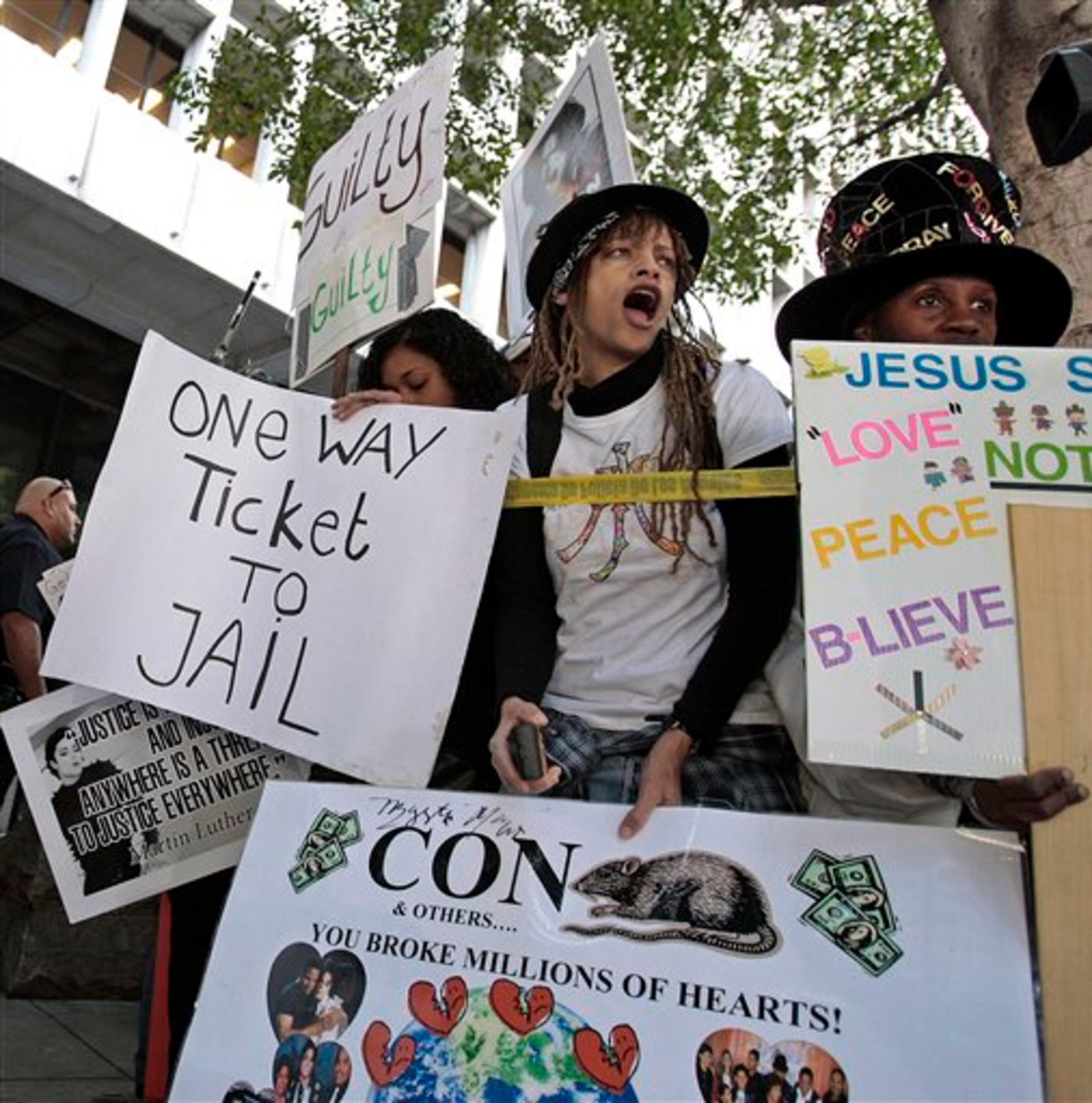 Demonstrators stand outside the Criminal Justice Center in downtown Los Angeles, Monday, Nov. 7, 2011 after it was announced that jurors had reached a verdict in the involuntary manslaughter trial of Dr. Conrad Murray, Michael Jackson's physician when the pop star died in 2009. (AP Photo/Bret Hartman)
