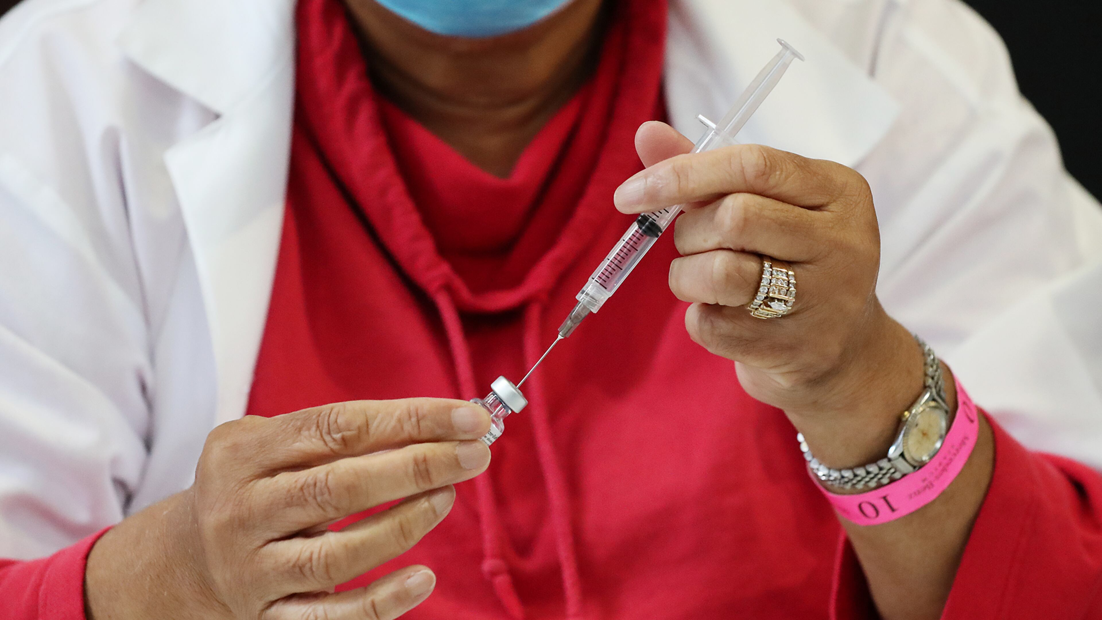 A nurse prepares a Pfizer vaccine earlier this year at an Atlanta vaccination site. “Curtis Compton / Curtis.Compton@ajc.com”