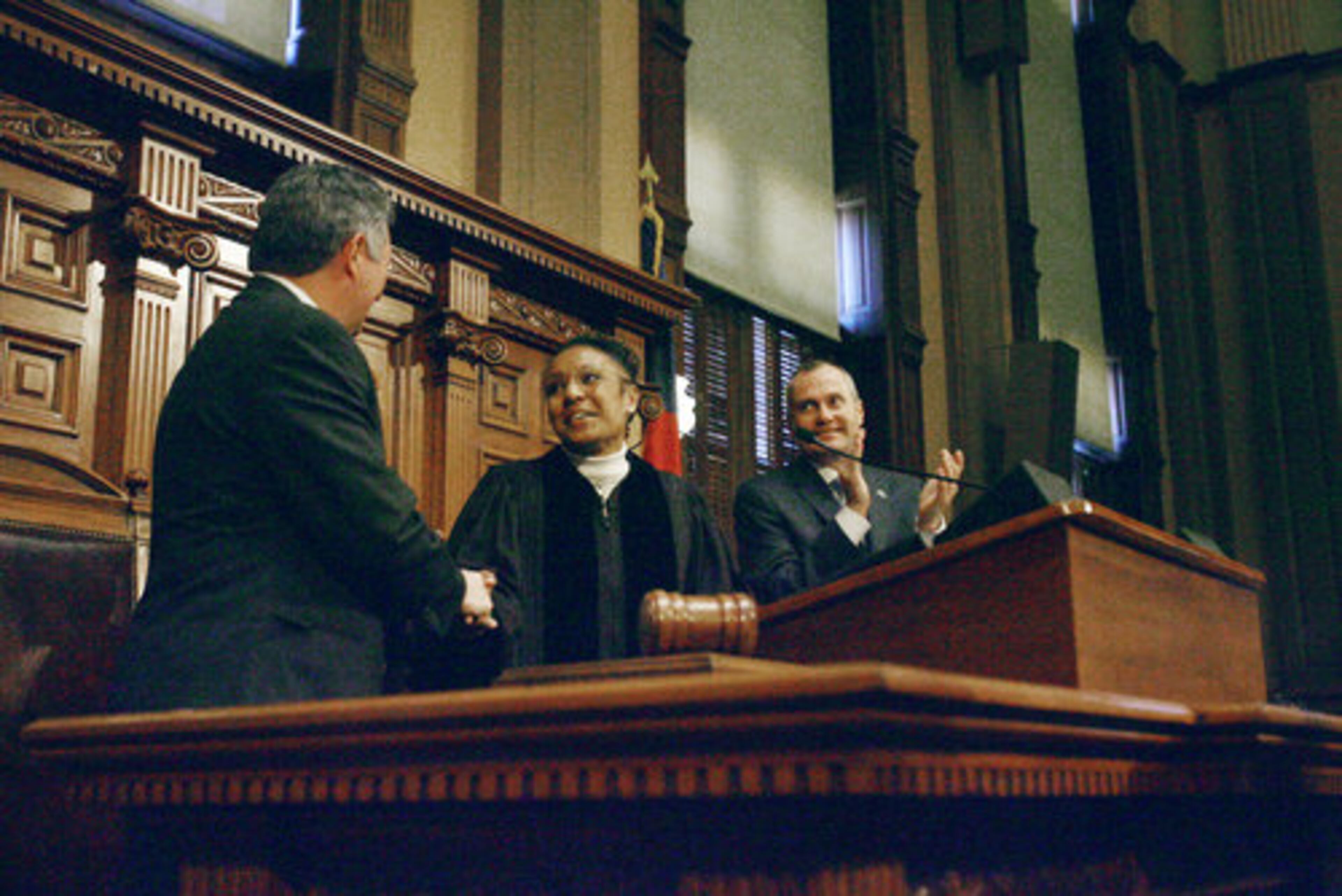 House speaker Glenn Richardson (left) R-Hiram, congratulates Georgia Supreme Court Chief Justice Leah Ward Sears (center) as Lt. Gov. Casey Cagle (right) applauds.