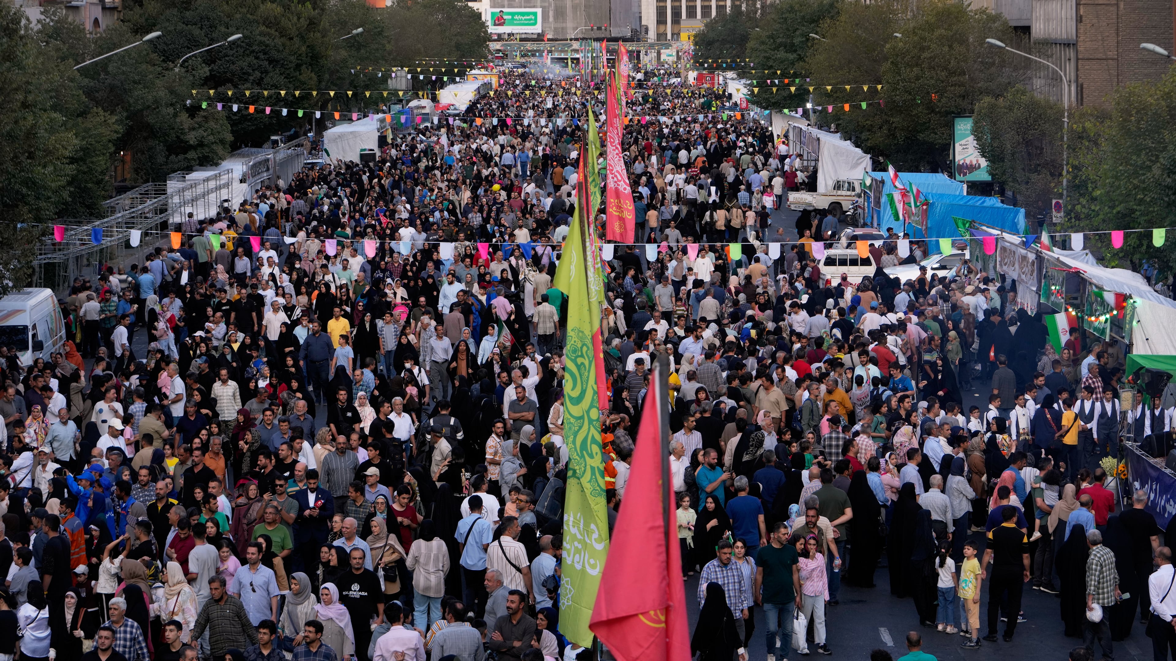 Crowds fill a street during celebrations marking Prophet Muhammad's birthday in Tehran, Iran, Sunday, Aug. 30, 2026. (AP Photo/Vahid Salemi)