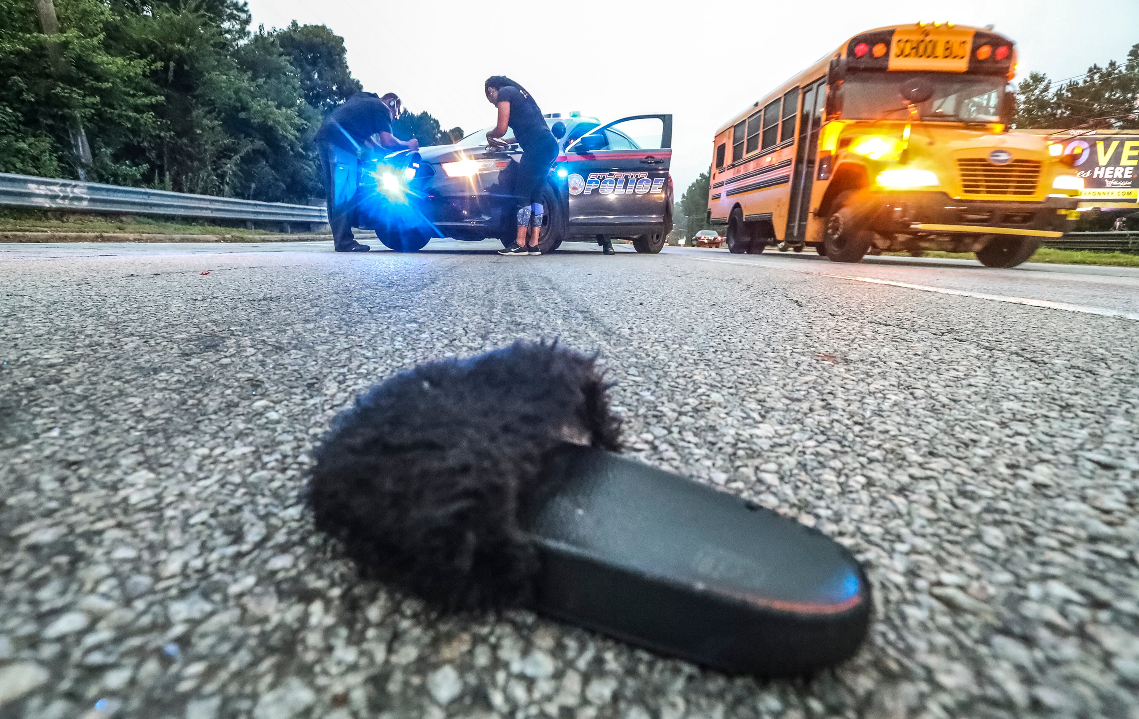 PEDESTRIAN ACCIDENT: Atlanta: footwear plays on the ground after a woman was transported to the hospital after she was struck by an 18-wheeler Wednesday morning, August 1, 2018 at 6:17 am on Campbellton Road near Butner Road. The Usher Transport Inc. truckâÃôs driver told police he tried to swerve to miss the woman as he traveled westbound on Campbellton Road. Police on the scene said the woman was alert, conscious and breathing when she was transported and would be charged with pedestrian in roadway. The driver was not charged. 1-westbound lane of traffic remained closed for 1-hour after the accident. JOHN SPINK/JSPINK@AJC.COM