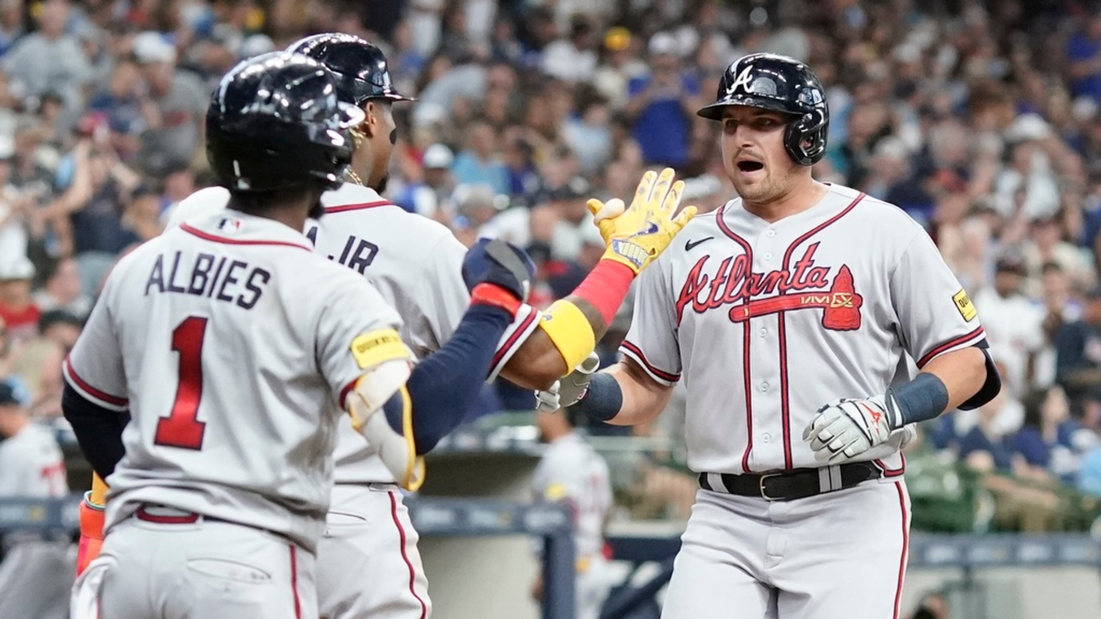 Atlanta Braves' Austin Riley is congratulated by Ronald Acuna Jr. and Ozzie Albies after hitting a three-run home run during the third inning of a baseball game against the Milwaukee Brewers Saturday, July 22, 2023, in Milwaukee. (AP Photo/Morry Gash)