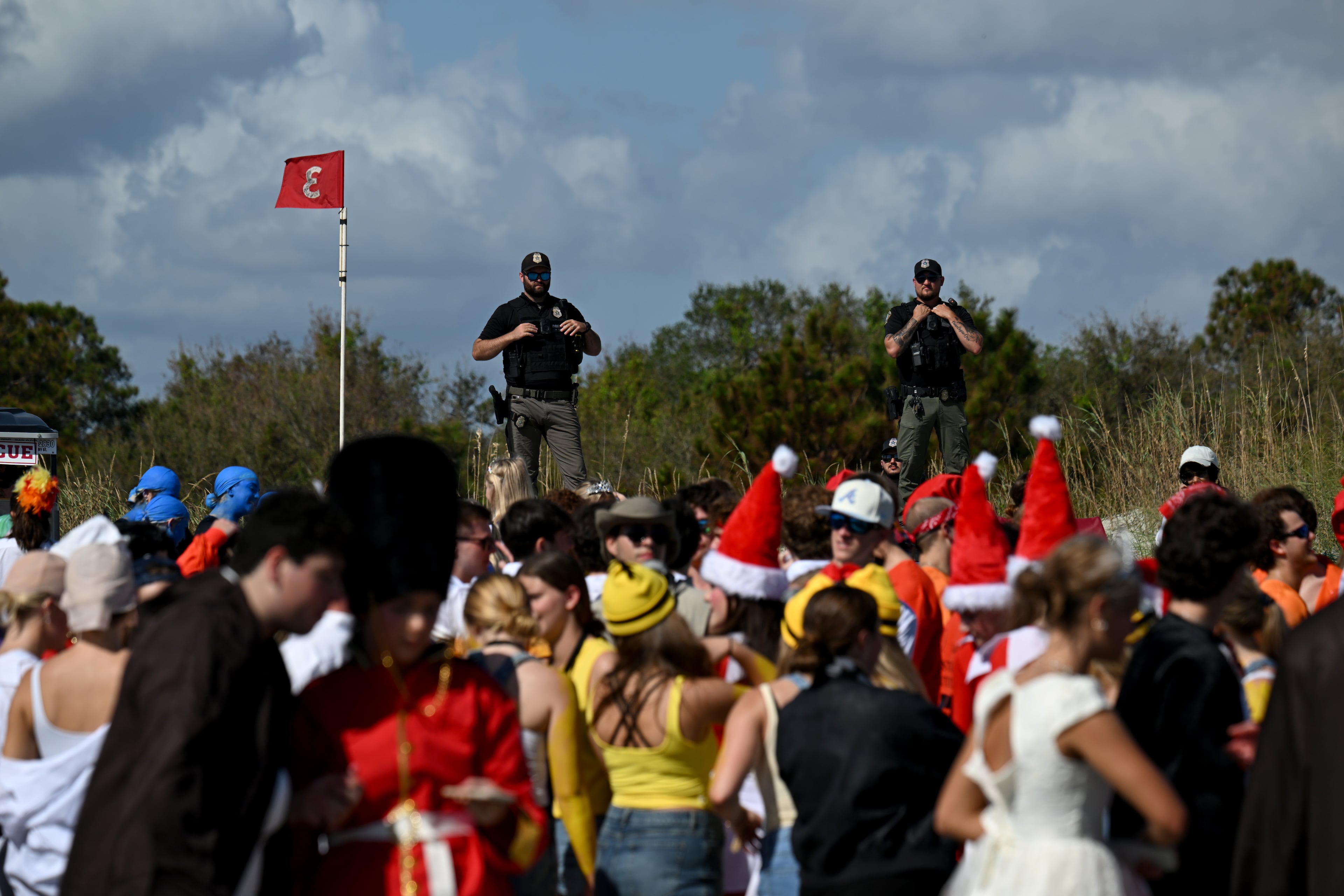 Local enforcement officers monitor during the annual “Frat Beach” party for the weekend of the Georgia-Florida football game on St. Simons Island, Friday, November 1, 2024. On the weekend of the Georgia-Florida football game, St. Simons Island’s East Beach becomes “Frat Beach,” an open-air party teeming with thousands of college students. (Hyosub Shin / AJC)