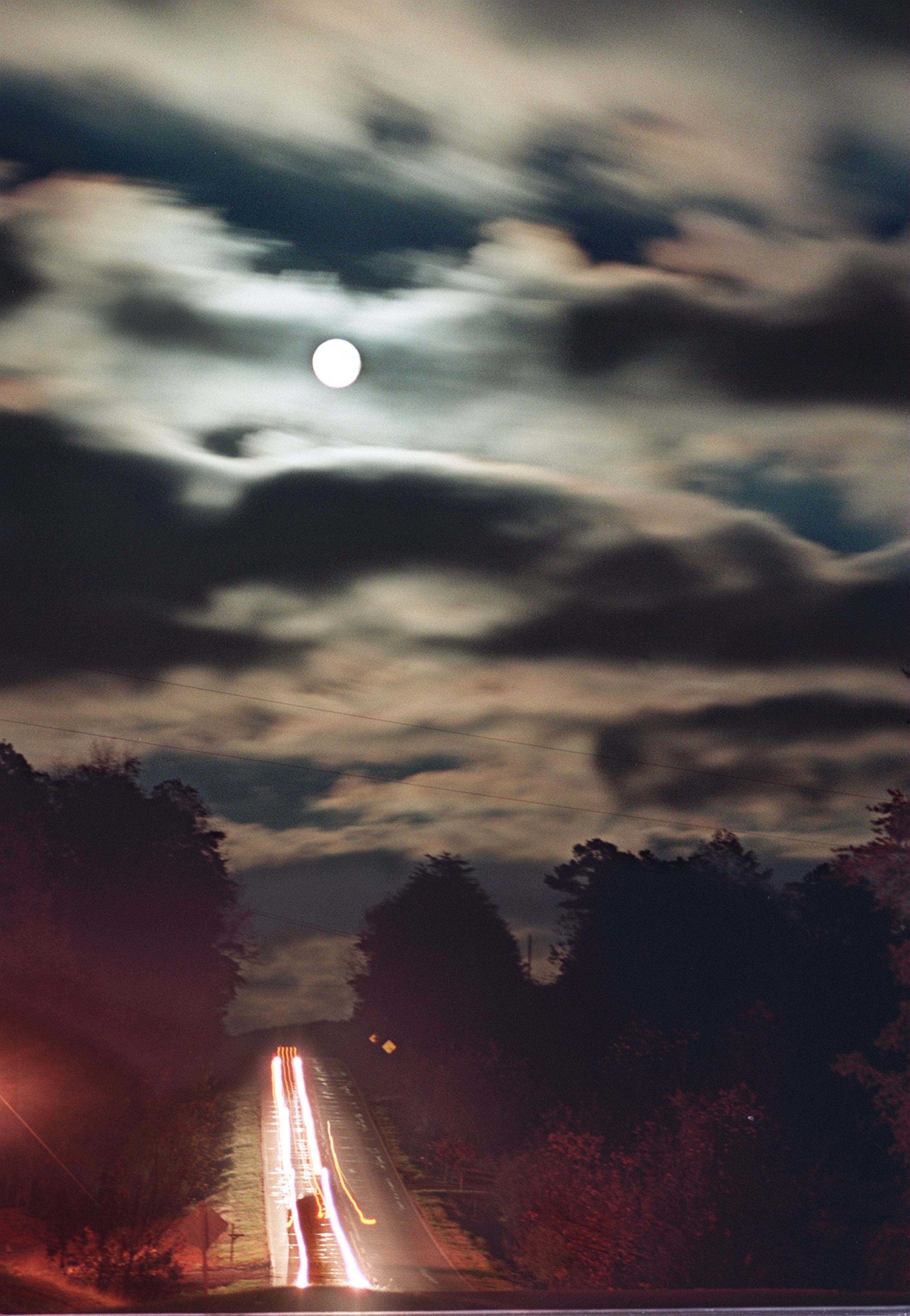 971114 A FEW MILES SOUTH OF CLEVELAND, GEORGIA IN NORTH GEORGIA : FOR USE AS A POSSIBLE END OF THE YEAR PHOTO (THIS PHOTO HAS NOT BEEN PUBLISHED). On November 14, 1997, we had a full moon over our skies. During the day, however, clouds threatened to obscure the shining moon. As dark rolled in over Georgia Highway 115 outside Cleveland, Georgia, however, the skies began to clear and the clouds did some quite interesting things as the moon came into and out of view. (AJC Staff Photo/Andy Sharp) 12/97