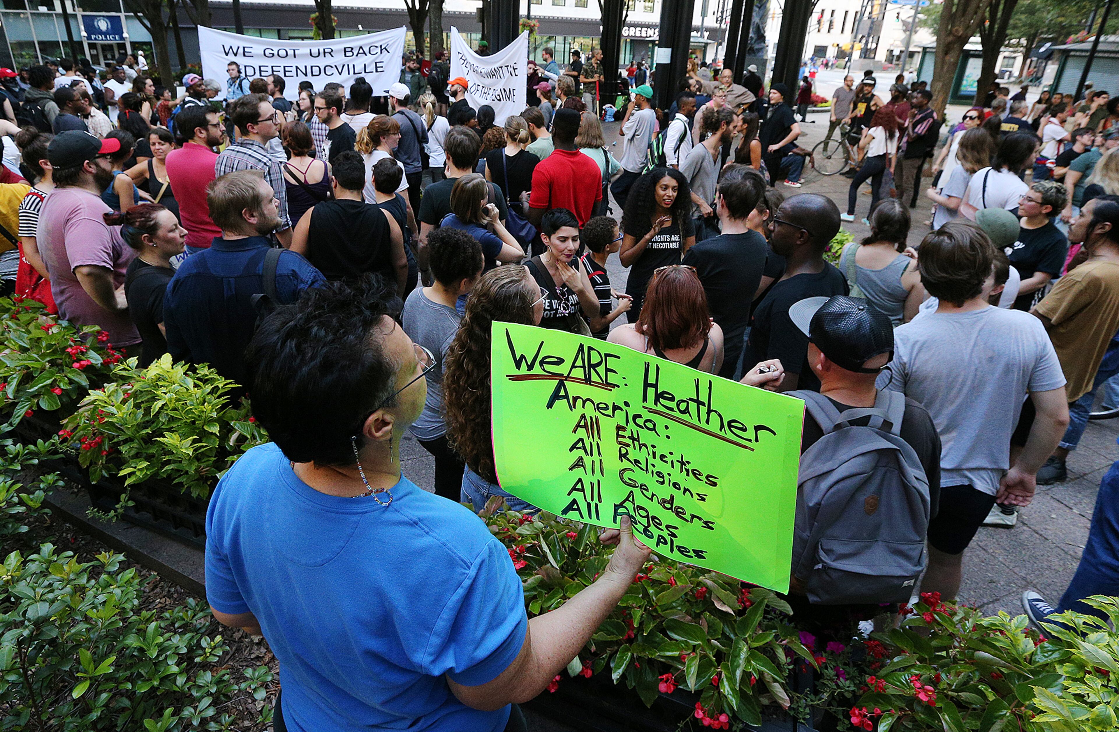 August 13, 2017 Atlanta: Suzanne Marks holds a sign for Heather Heyer as hundreds gather for a anti white nationalism memorial and march in response to violence in Virginia at Woodruff Park on Sunday, August 13, 2017, in Atlanta. Curtis Compton/ccompton@ajc.com