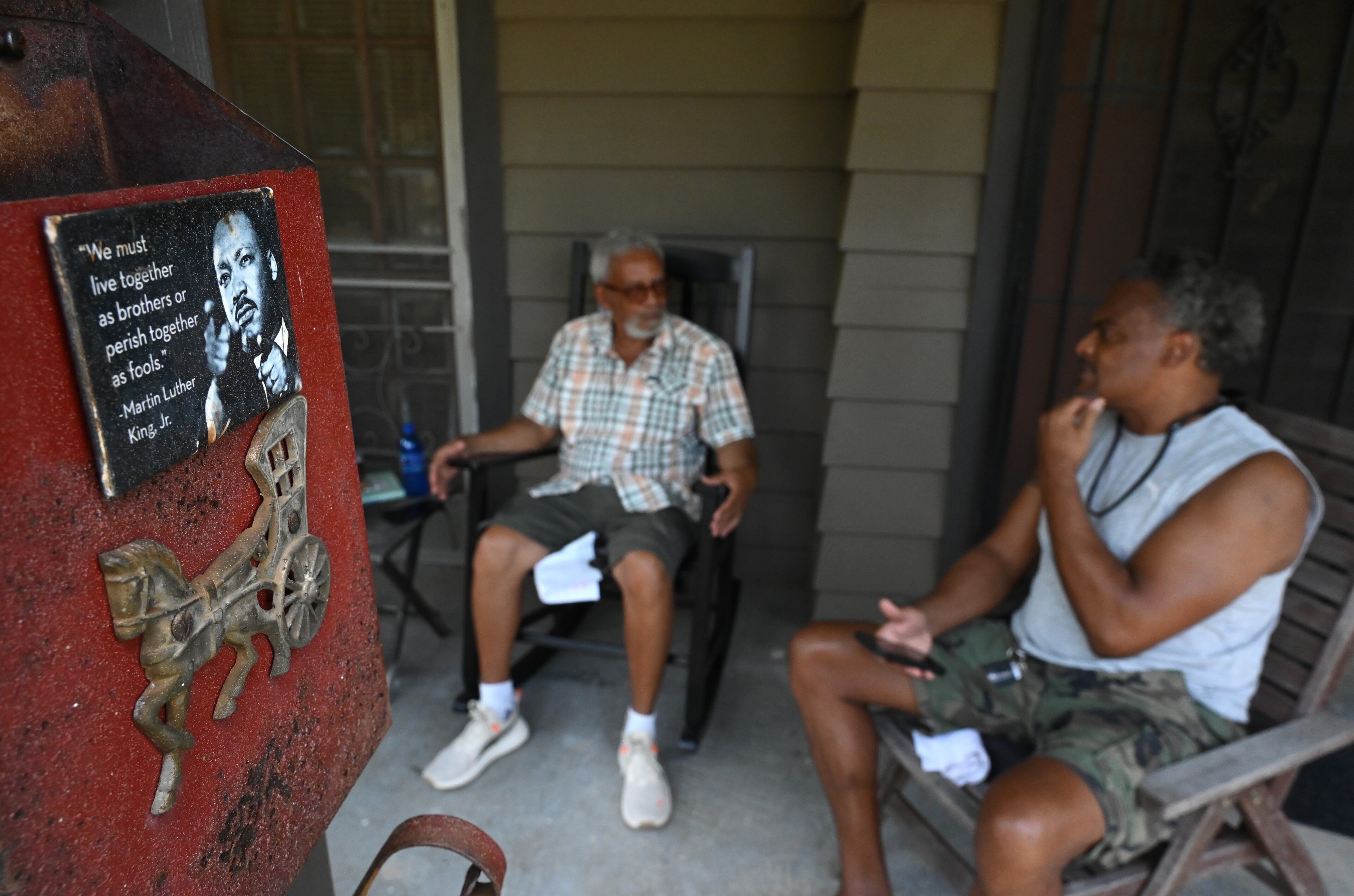 Albert B. Cooper IV (left) and Forrest Coley discuss Atlanta Medical Center with other residents of the Old Fourth Ward community. (Hyosub Shin/AJC)