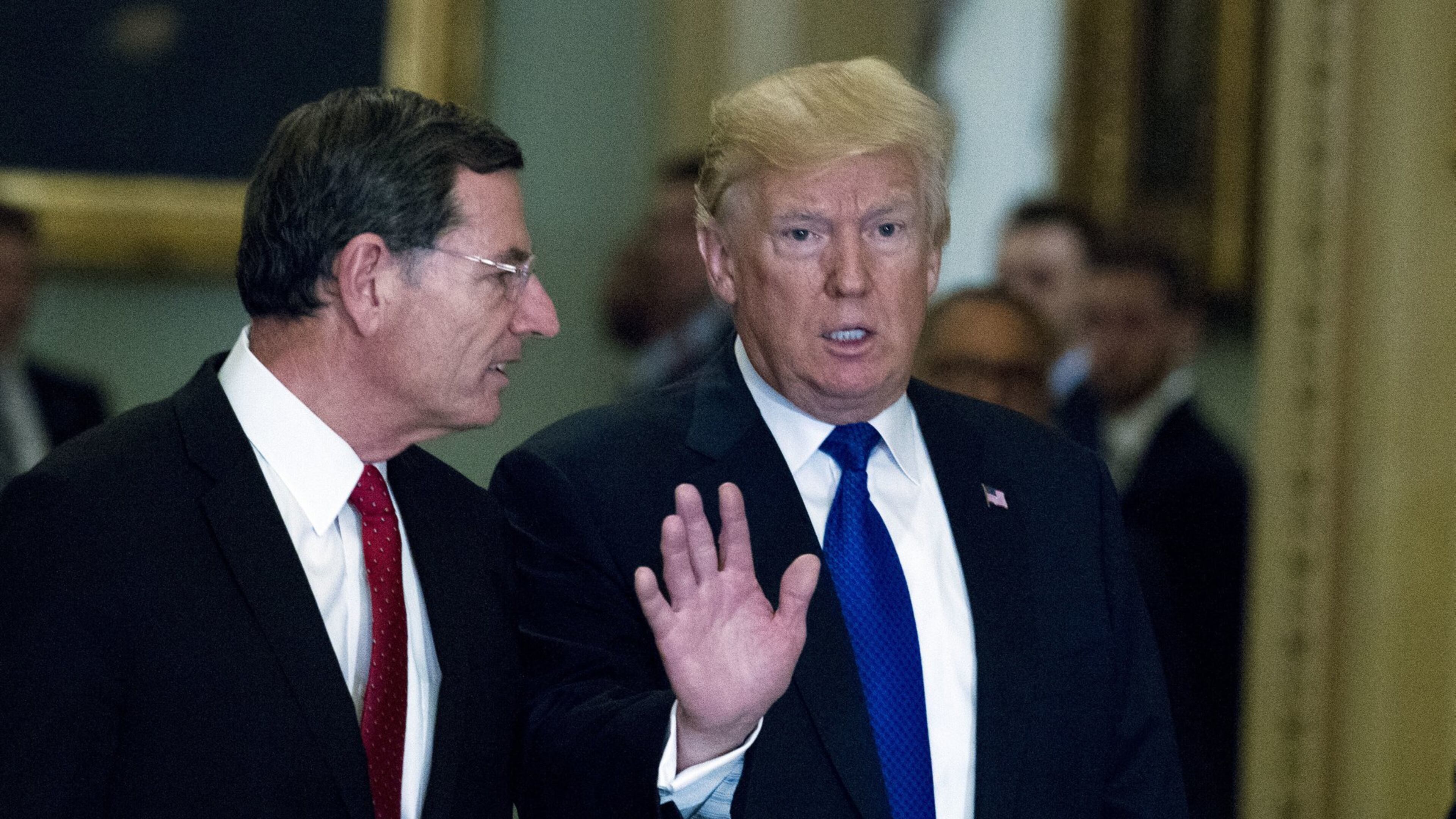 President Donald Trump escorted by Sen. John Barrasso, R-Wyo., chairman of the Senate Republican Policy Committee, arrives at the Capitol to meet with GOP lawmakers about moving his agenda and passing the Republican tax bill, in Washington, Tuesday, Nov. 28, 2017. ( AP Photo/Jose Luis Magana)