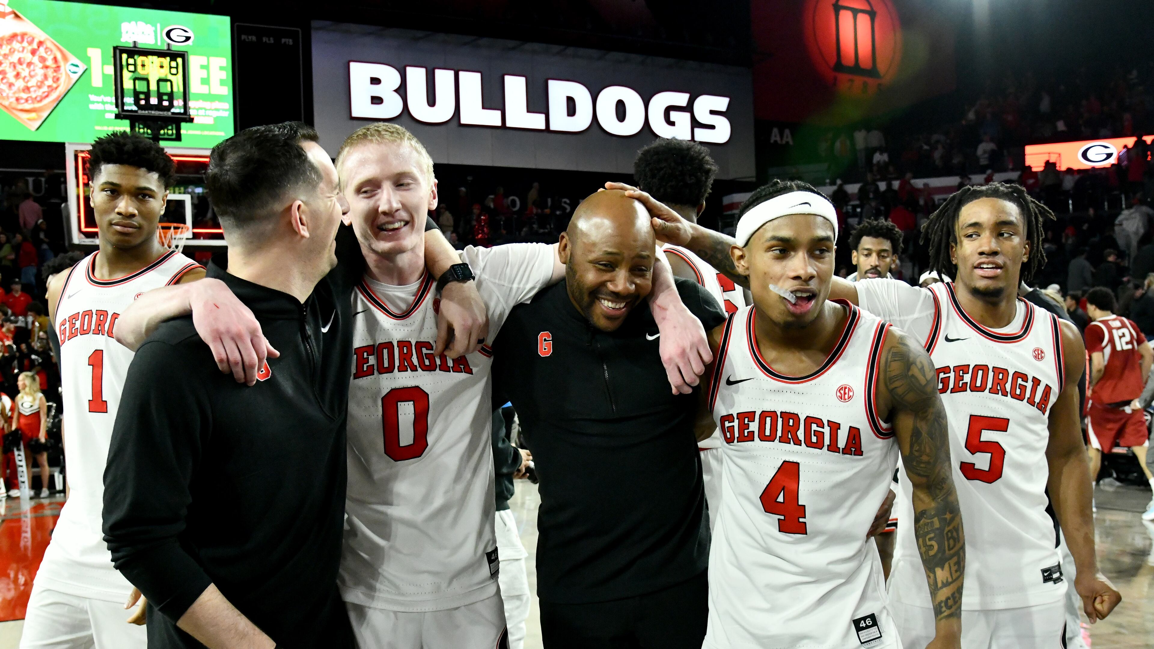 Georgia players and coaches celebrate Georgia's 90-76 win over Arkansas on Saturday, Jan. 17, 2026, at Stegeman Coliseum in Athens. (Hyosub Shin/AJC)