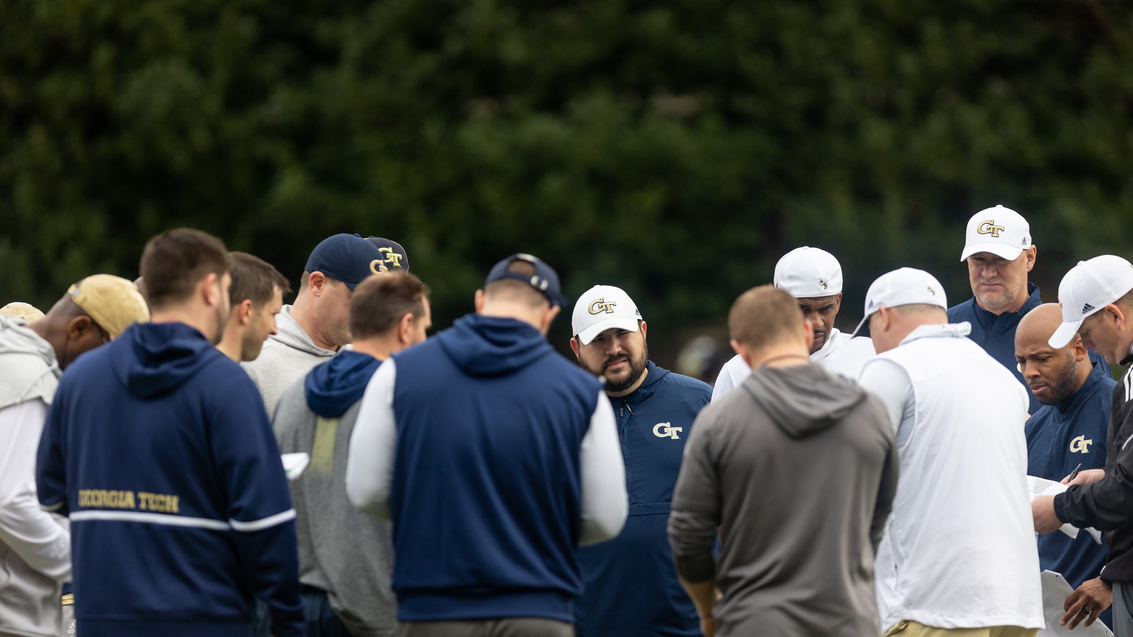 The coaching staff huddles during the first day of spring practice for Georgia Tech football at Alexander Rose Bowl Field in Atlanta, GA., on Thursday, February 24, 2022. (Photo Jenn Finch)