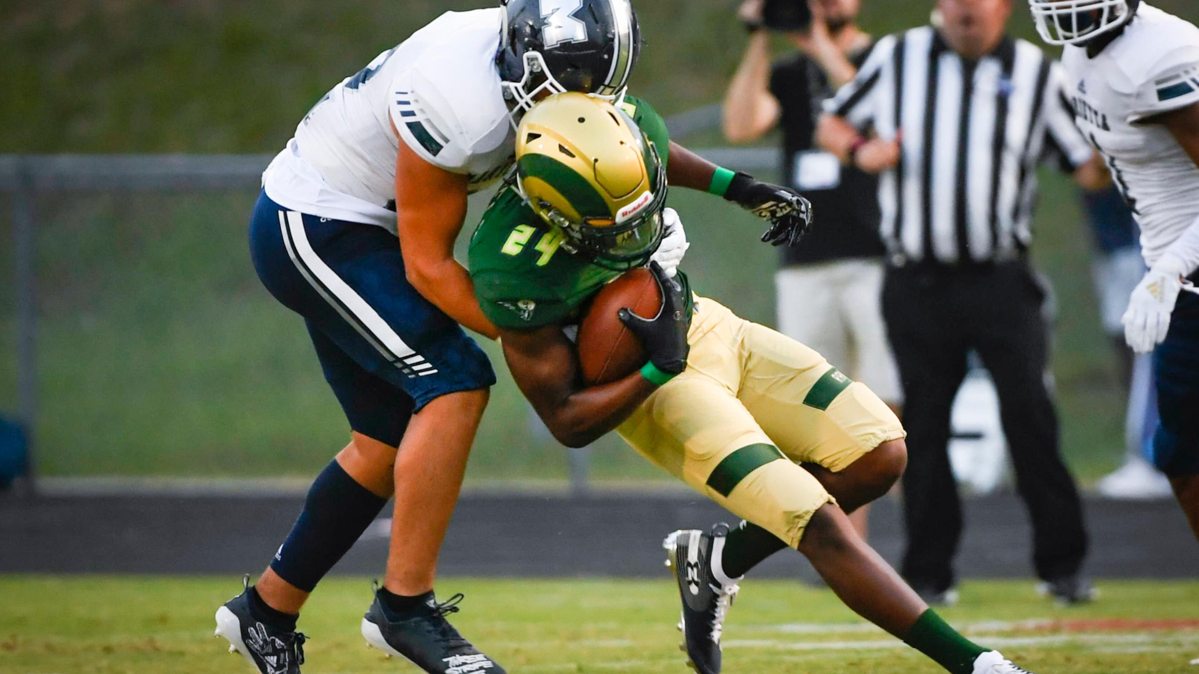 Grayson WR Darius Daniel is tackled by Marietta LB Carlos Cervante during the first half of Friday's game. (John Amis/Special)