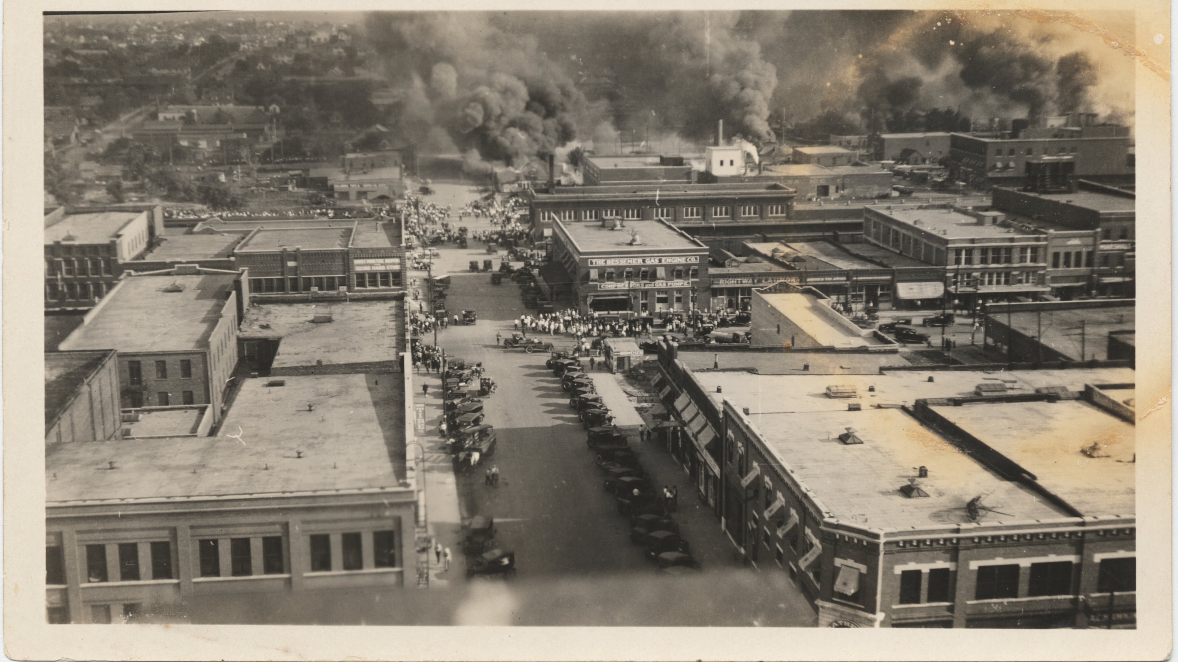 This photo provided by The University of Tulsa and taken from the roof of the Tulsa Hotel shows a crowd gathering to watch the fire in the morning of June 1, 1921, in Tulsa, Okla. (The University of Tulsa McFarlin Library/Department of Special Collections and University Archives via AP)