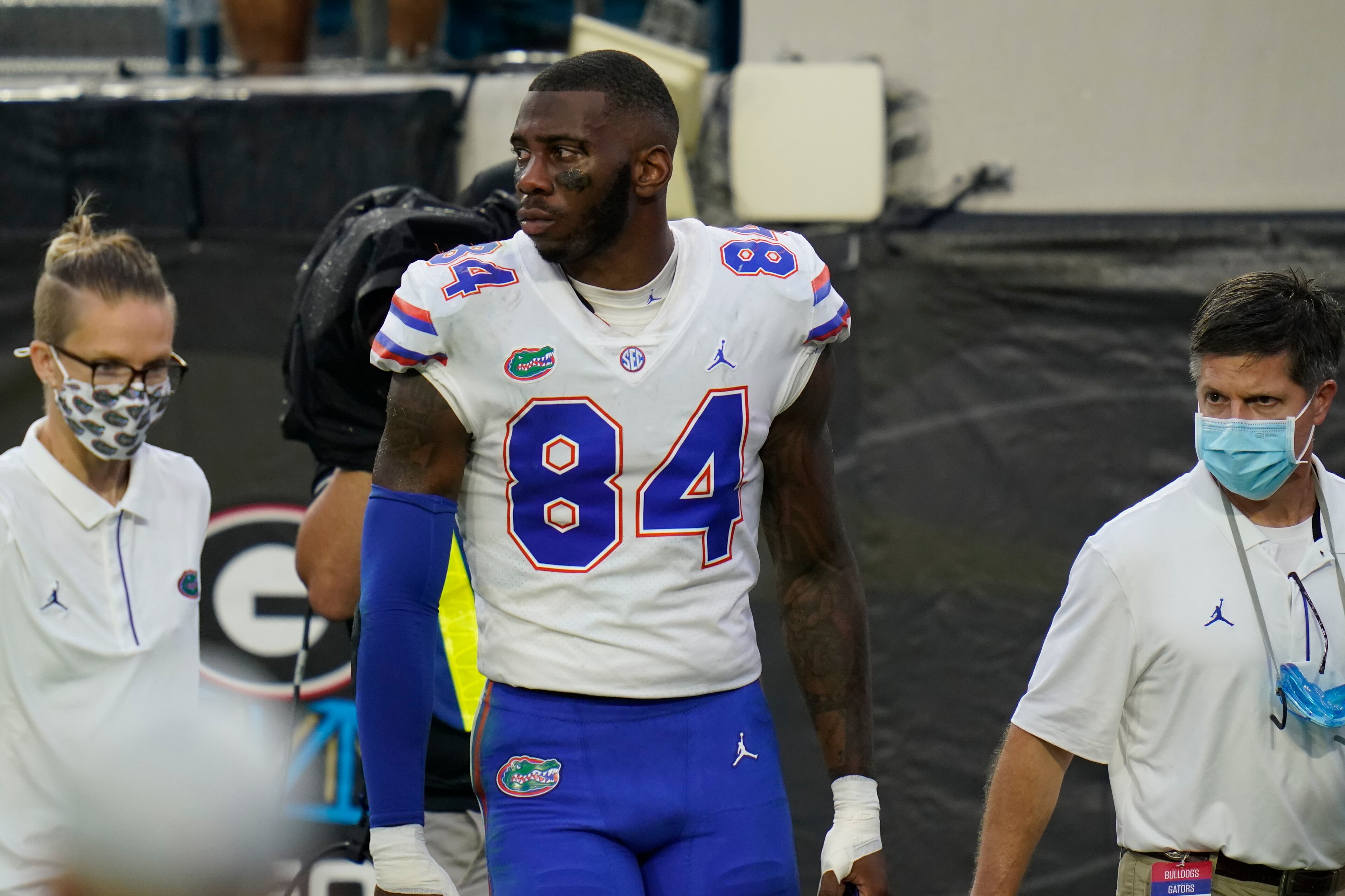 Florida tight end Kyle Pitts, center, is escorted off the field after he was injured during the first half of an NCAA college football game against Georgia, Saturday, Nov. 7, 2020, in Jacksonville, Fla. (AP Photo/John Raoux)