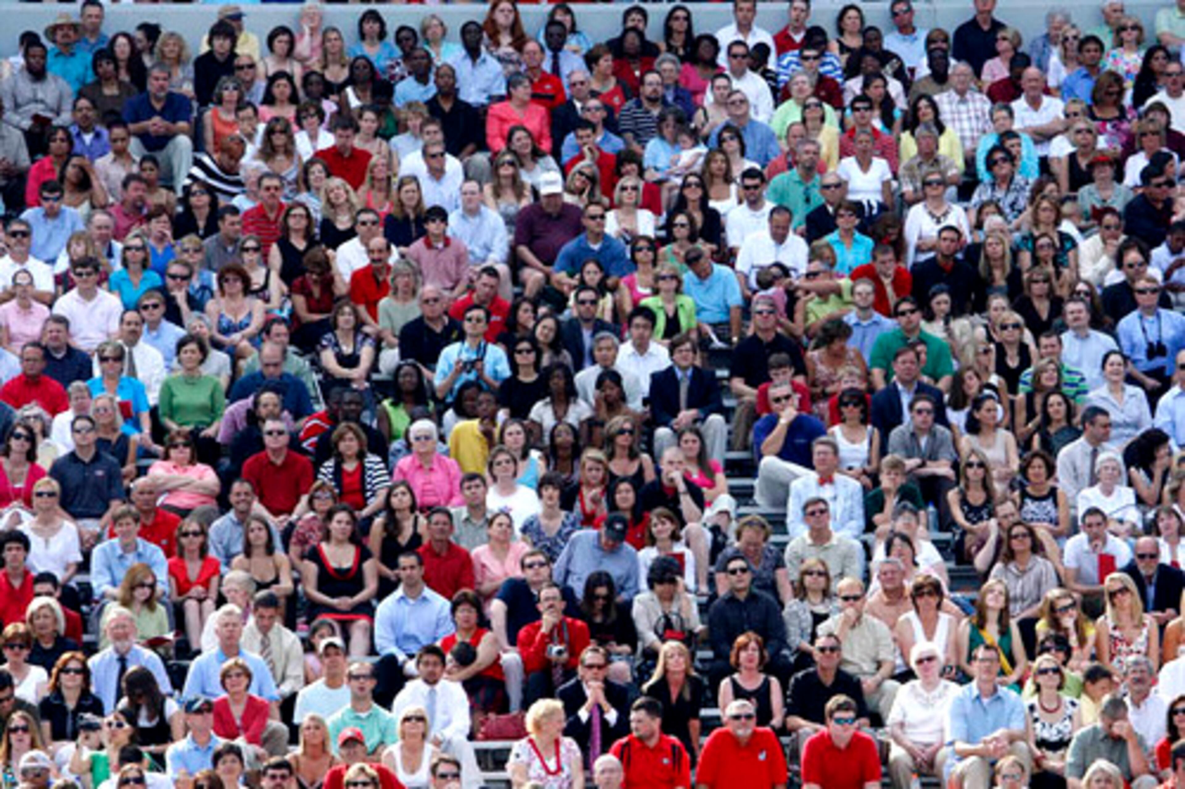 Parents and friends sit in the stands.
