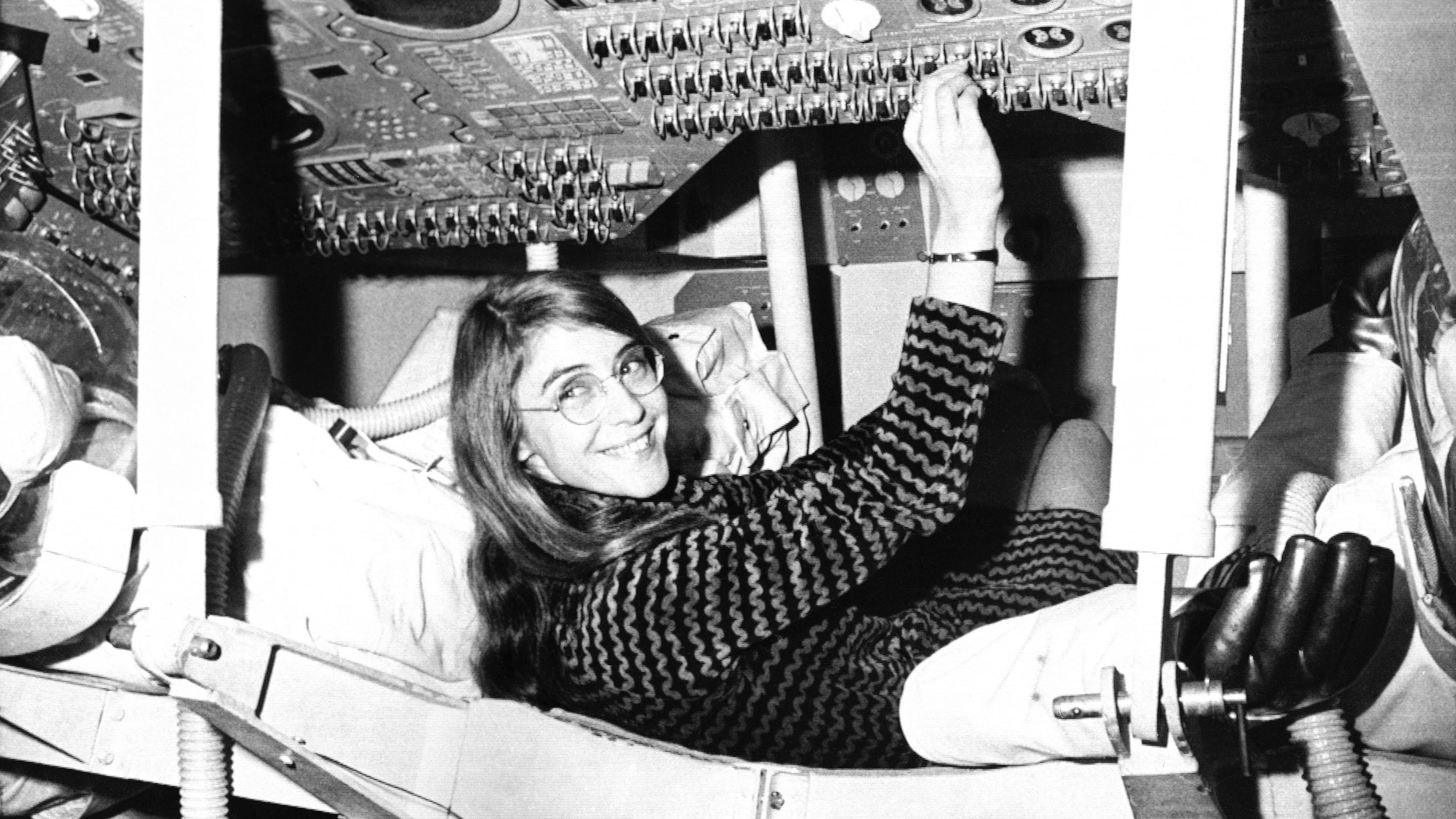 FILE - Margaret Hamilton of Cambridge, Mass., mathematic and computer programmer at the MIT Instrumentation Laboratory, sits in mock up of Apollo command module on display at the Cambridge school, Nov. 25, 1969 where she headed group that programmed Intrepid's pinpoint landing in the Sea of Storms on the moon. (AP Photo, File)