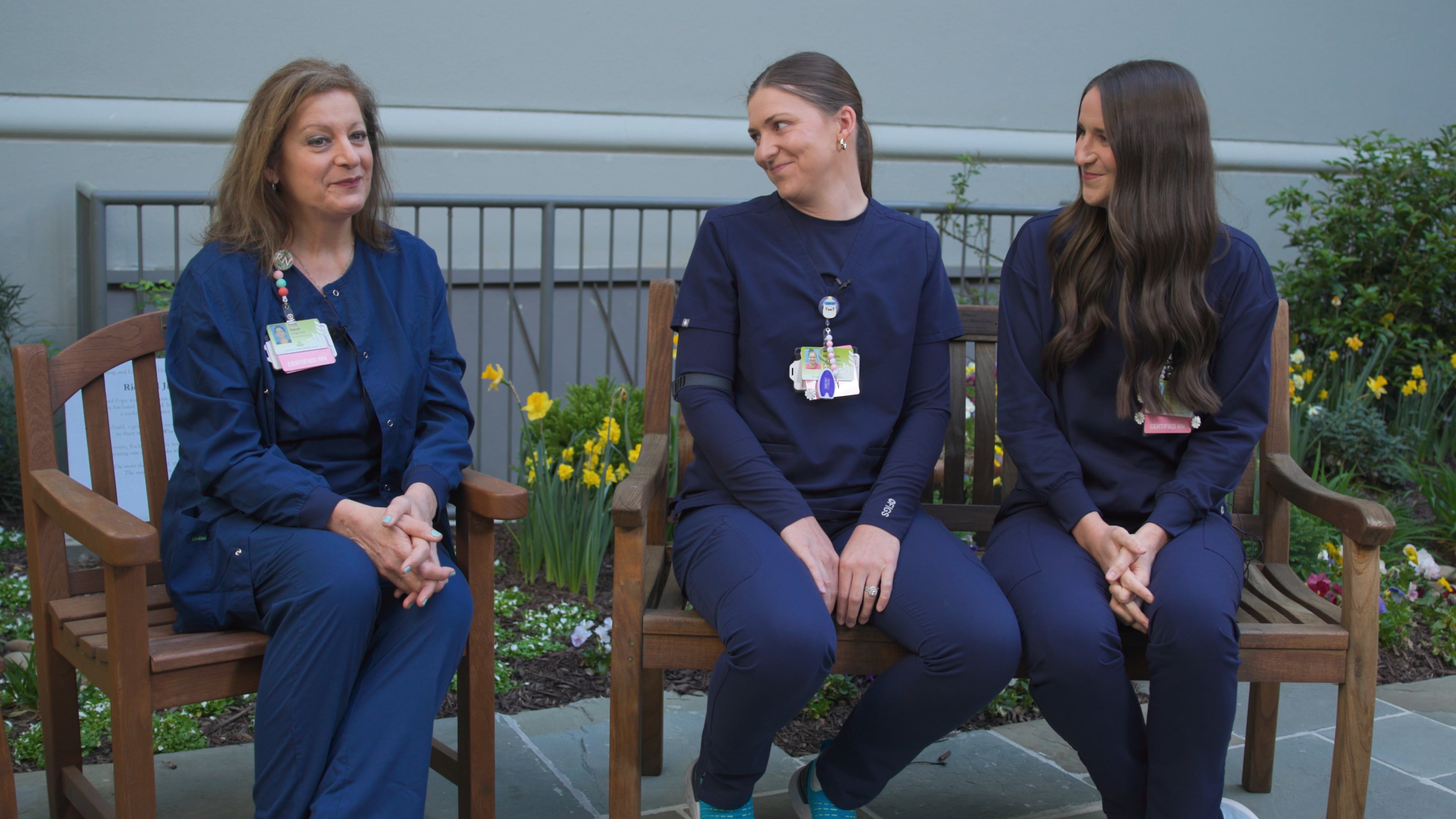 Sarah Rushton (left) sits with twin daughters, McKenna Roberts (center) and Mary Kate Harris, who are also nurses at Northeast Georgia Medical Center in Gainesville. Sarah gave birth to the twins at the hospital, where Sarah has spent 42 years and the twins have worked 10 years bringing new babies into the world. (Courtesy of Northeast Georgia Medical Center)