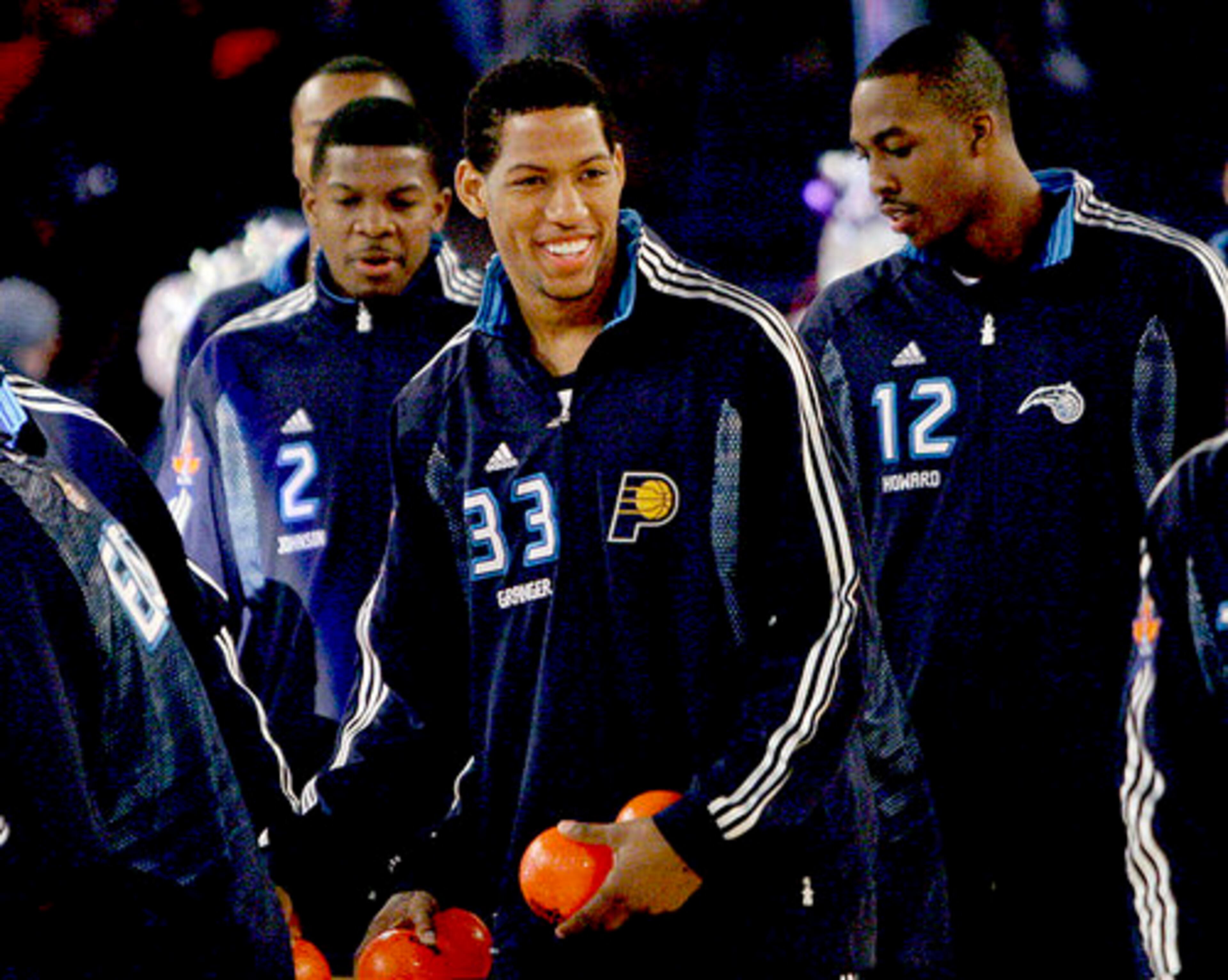 Members of the Eastern All-Star team, among them the Hawks' Joe Johnson (2), Danny Granger (33) of the Pacers, and Dwight Howard (12) of the Orlando Magic enter the arena before the NBA All-Star basketball game.