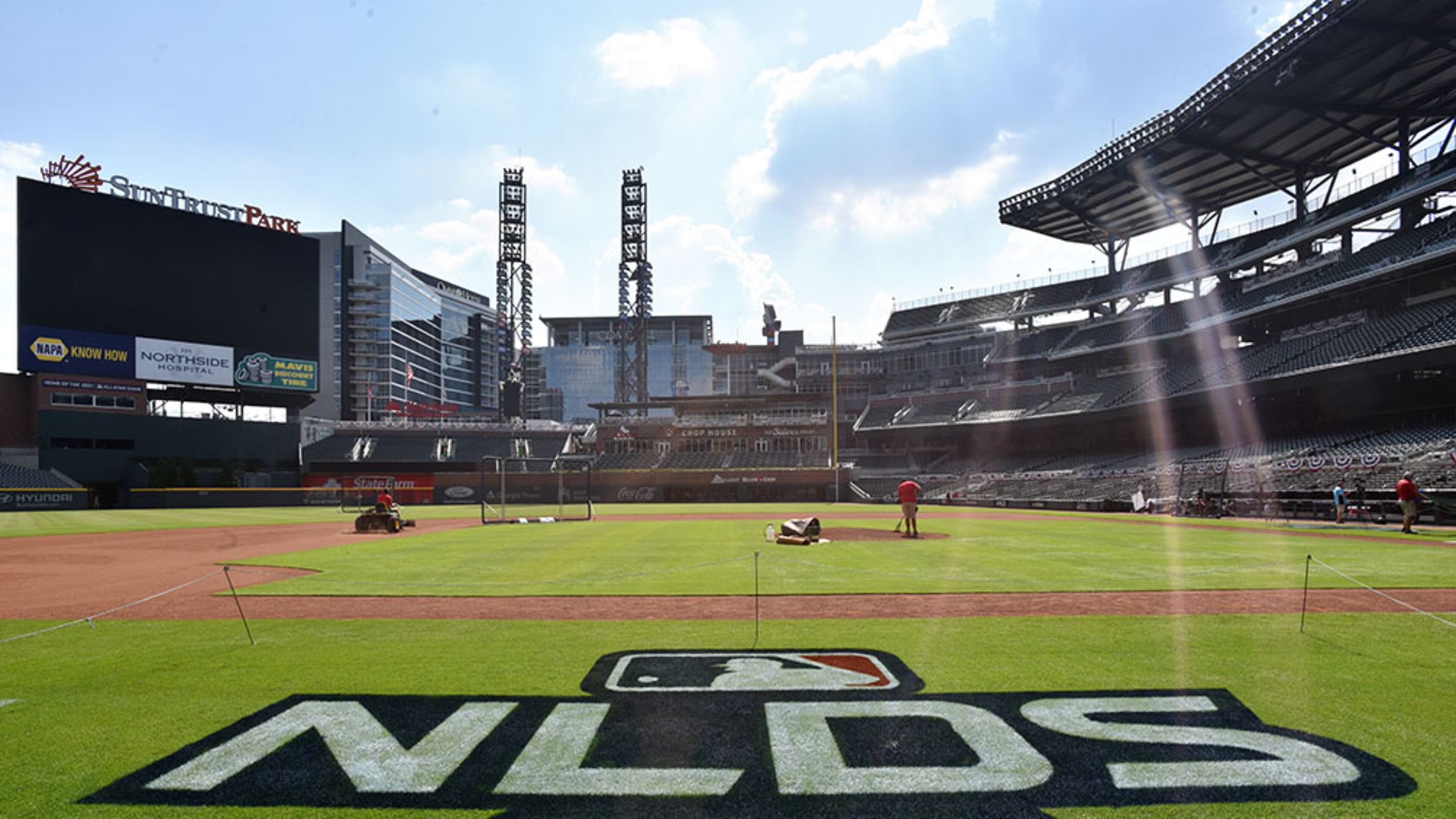 The grounds crew works on the SunTrust Park field a day before Thursday's Game 1 of the best-of-five National League Division Series between the Braves and St. Louis Cardinals . (Hyosub Shin / Hyosub.Shin@ajc.com)