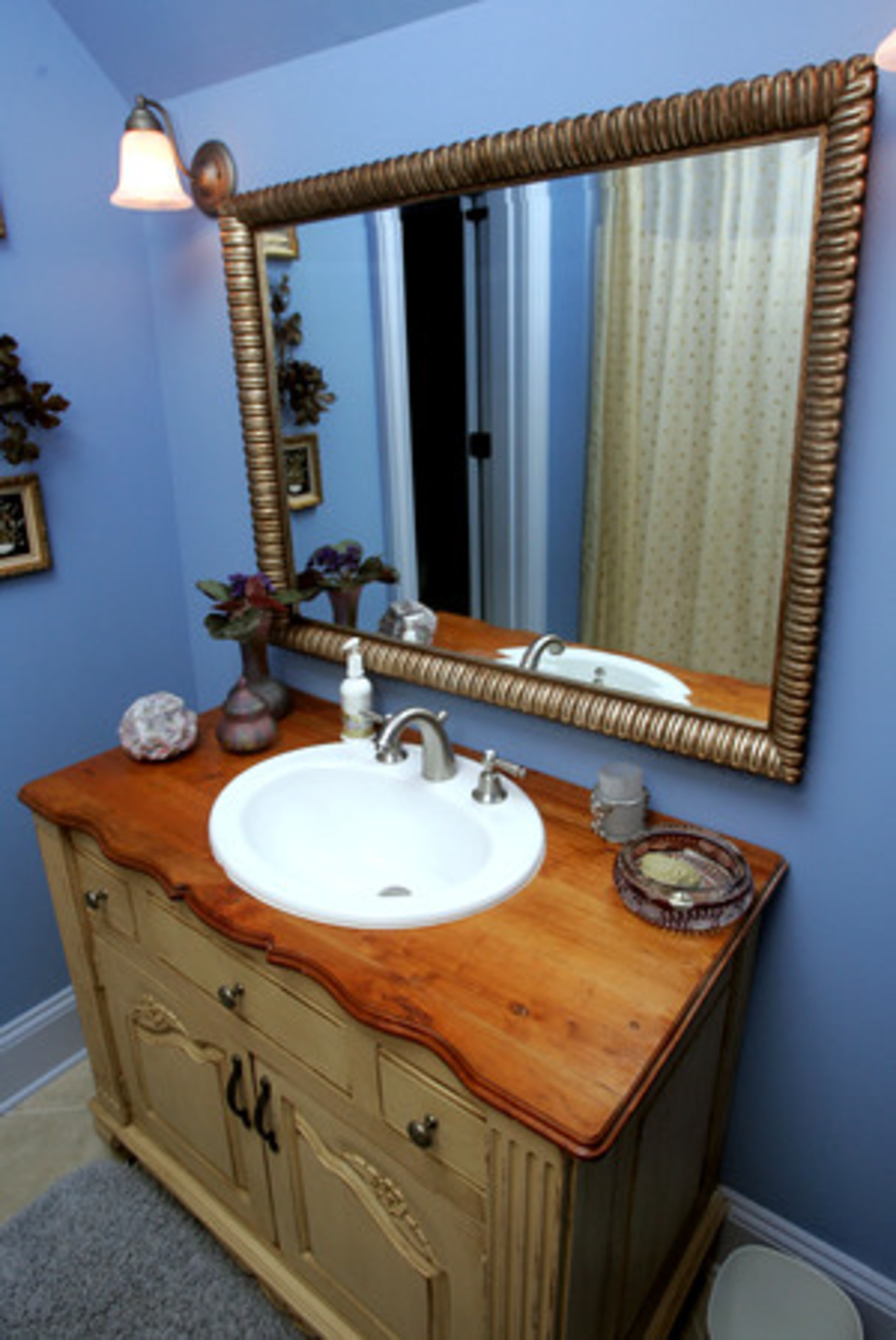 Sandy Beecham favors purple and blue hues throughout her home, as seen in this guest bathroom upstairs.