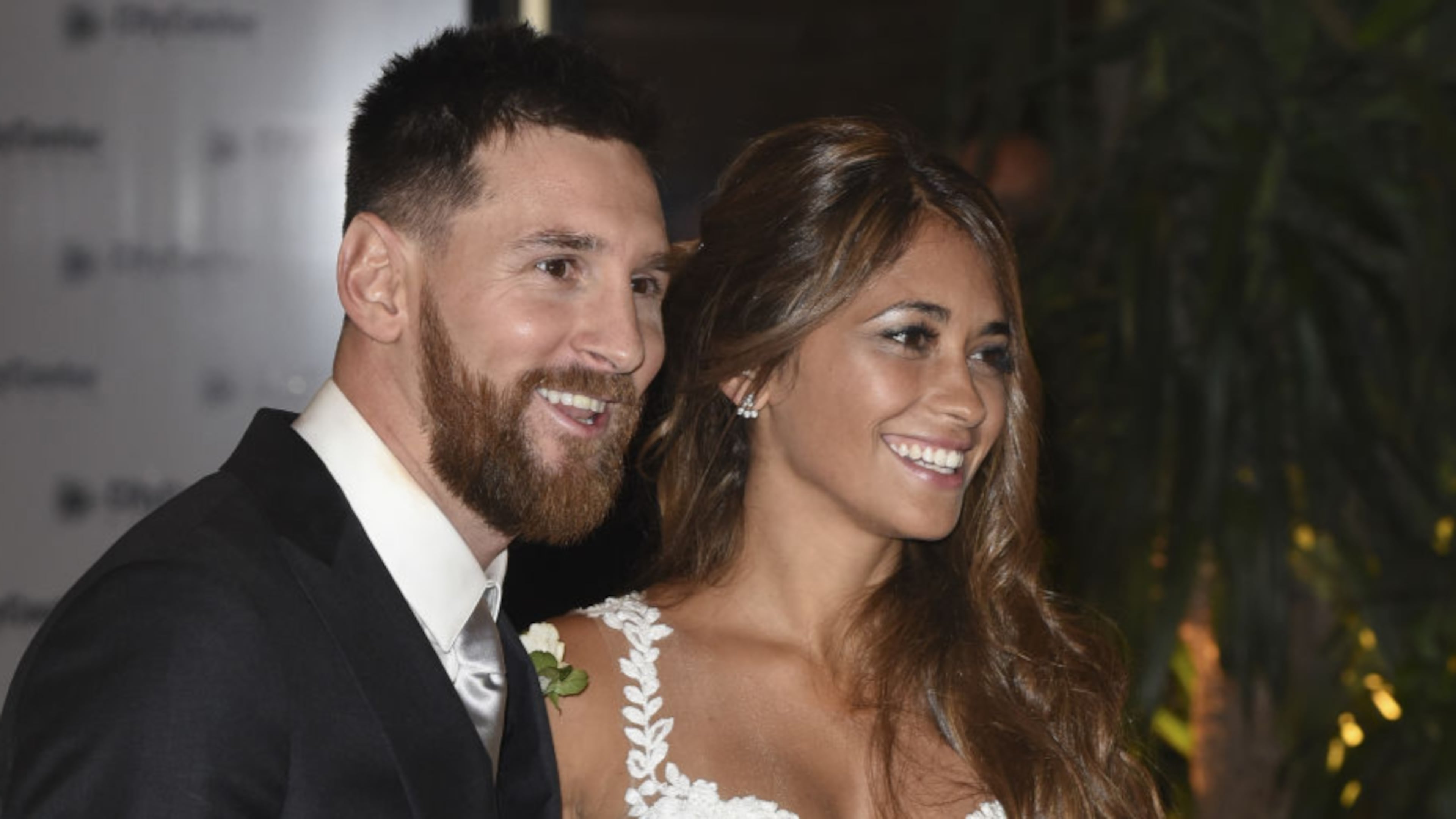 Lionel Messi and Antonela Roccuzzo greet the press after their civil wedding ceremony at the City Center Rosario Hotel & Casino on Friday.