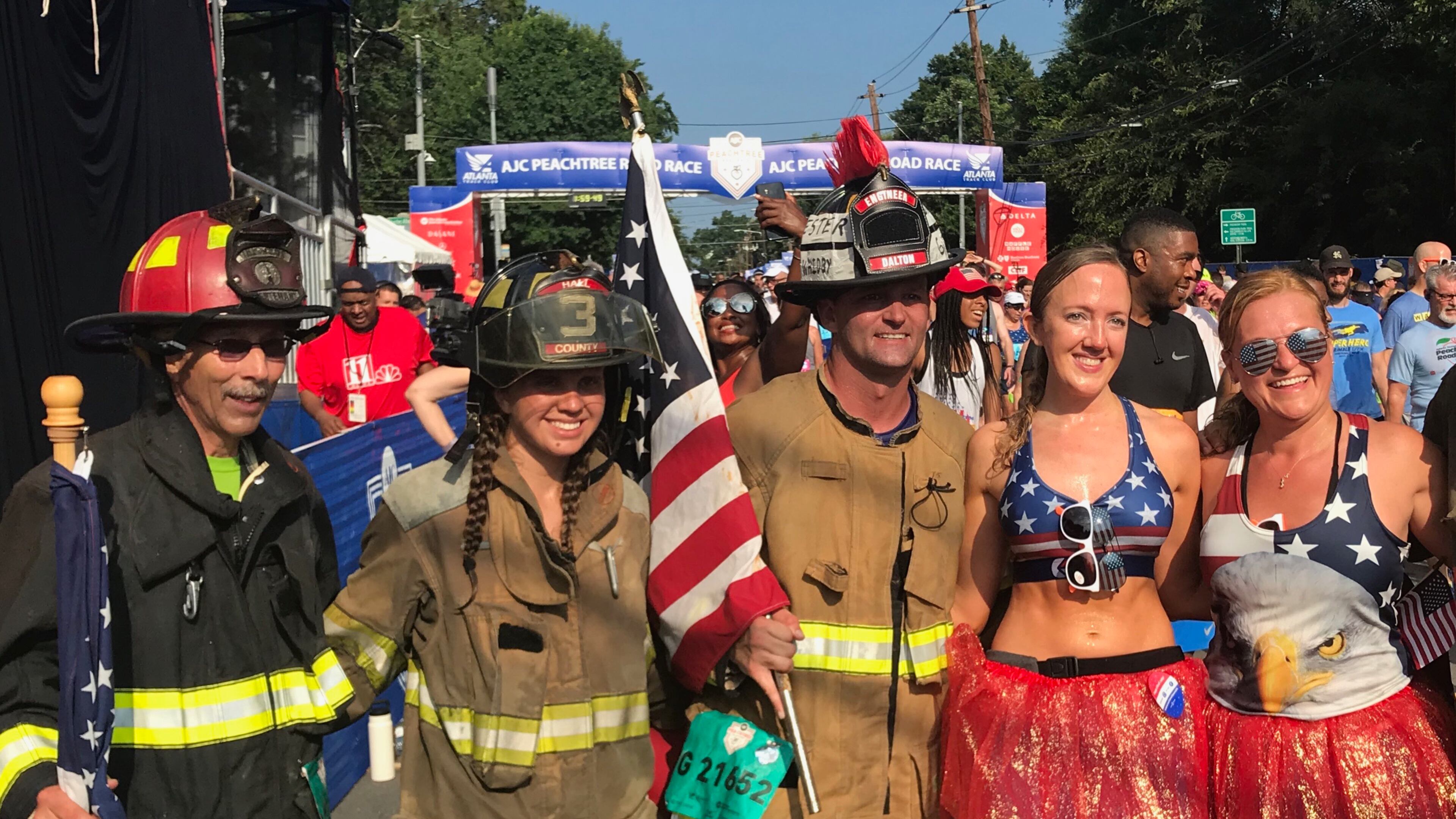 Participating firefighters take a photo after finishing the AJC Peachtree Road Race on Wednesday, July 4, 2018. (Photo by Zachary Hansen/AJC)