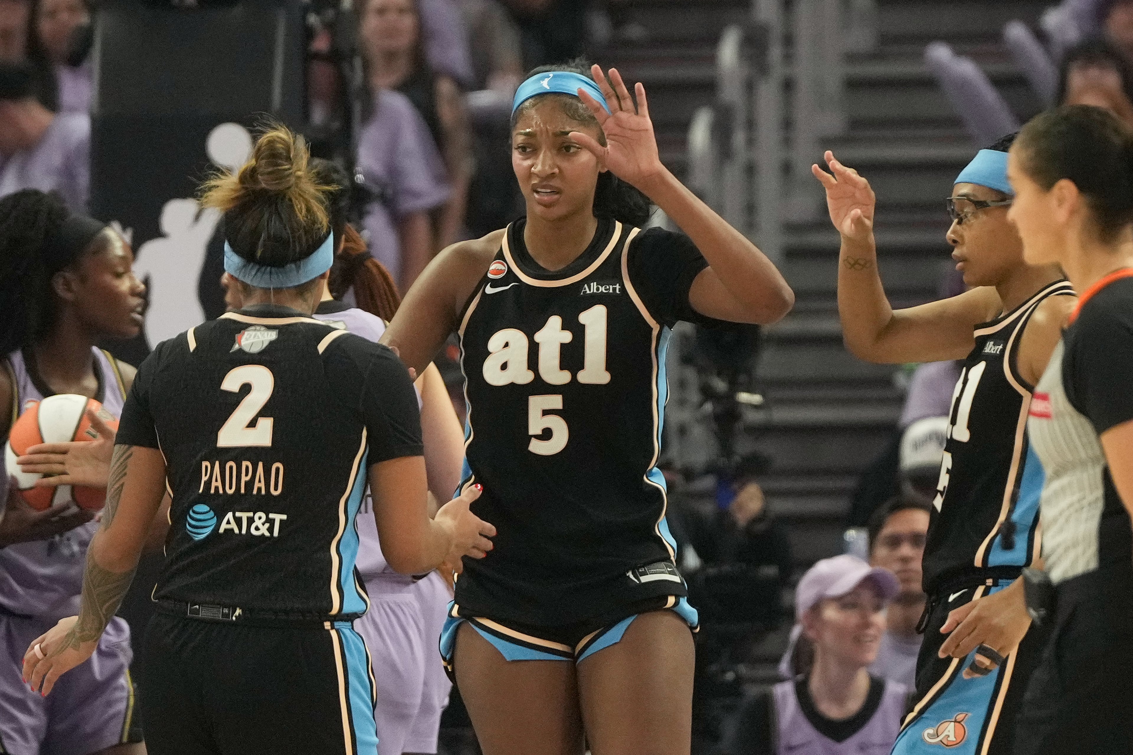 Atlanta Dream forward Angel Reese (5) celebrates with guard Te-Hina Paopao (2) and guard Allisha Gray, right, during the first half of Game 5 of the WNBA basketball finals against the Golden State Valkyries, Monday, Oct. 26, 2026, in San Francisco. (AP Photo/Jeff Chiu)