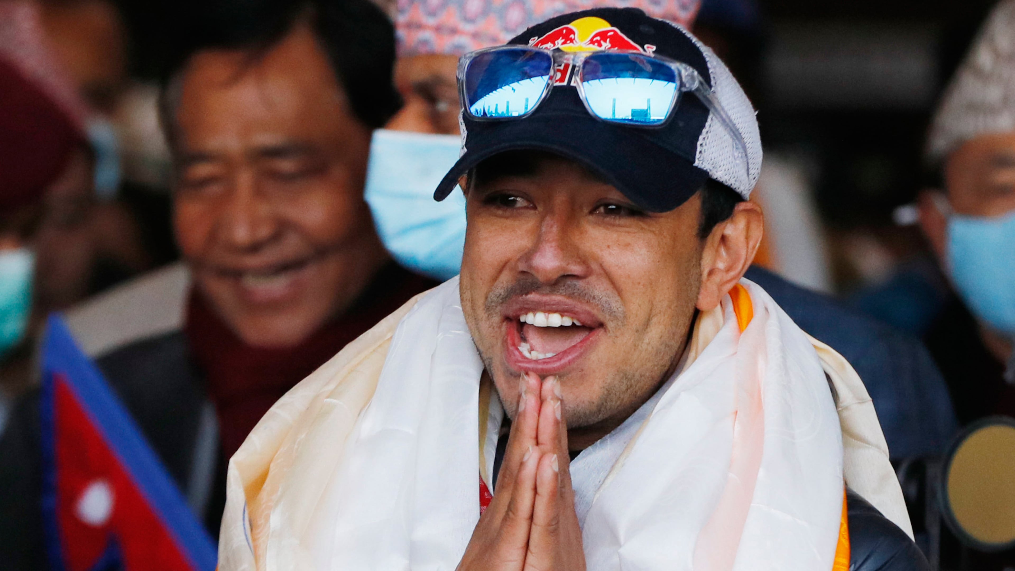 FILE - Nirmal Purja, one of the team member of the all-Nepalese mountaineering team that became the first to scale Mount K2 in winter, gestures as the team arrives at Tribhuwan International airport in Kathmandu, Nepal, Jan. 26, 2021. (AP Photo/Niranjan Shrestha, File)