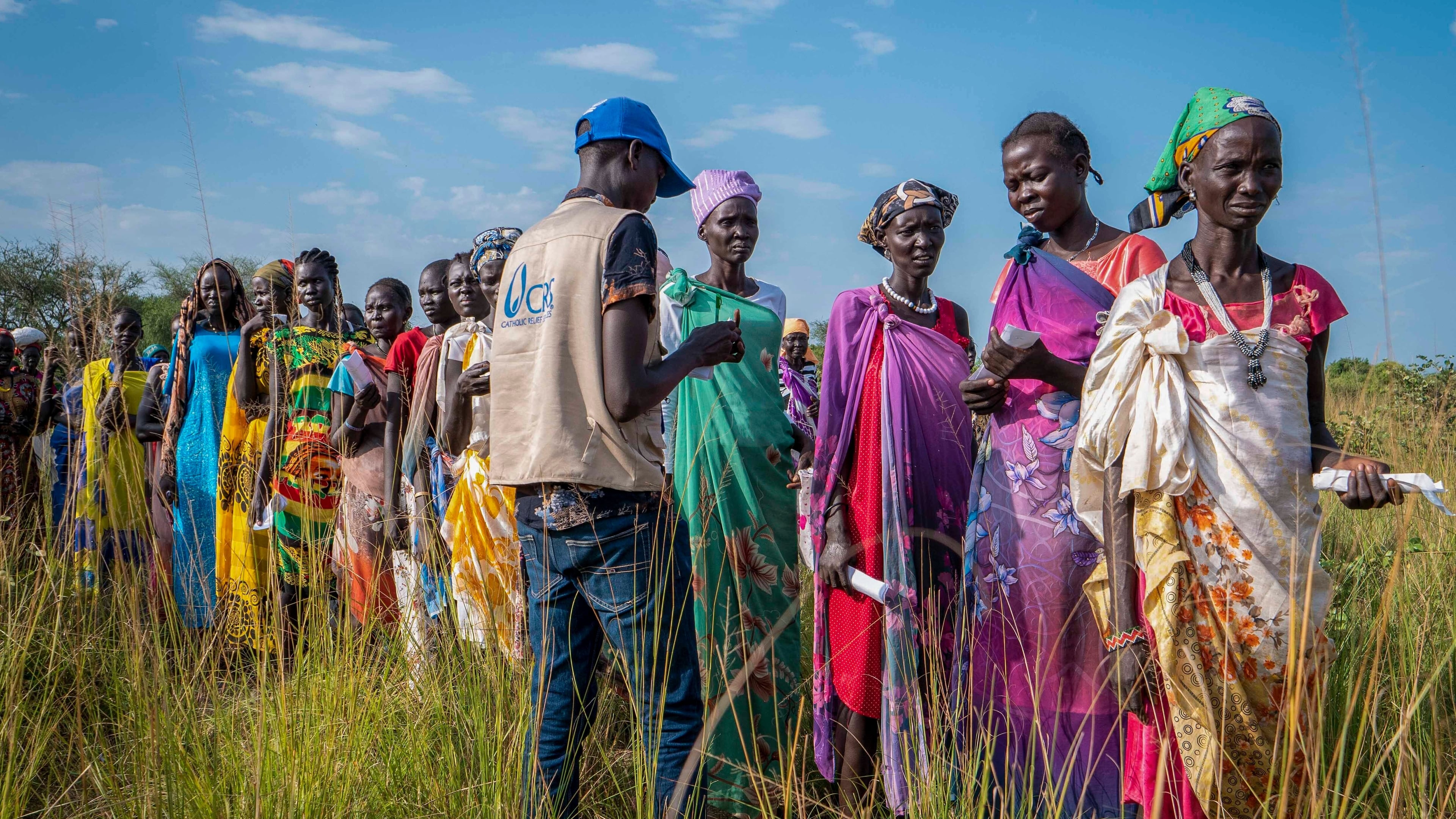 FILE - South Sudanese women line up for food rations at a World Food Programme (WFP) distribution point organized by Catholic Relief Services in Jonglei state, South Sudan, Wednesday, Nov. 13, 2024. (AP Photo/Florence Miettaux, File)