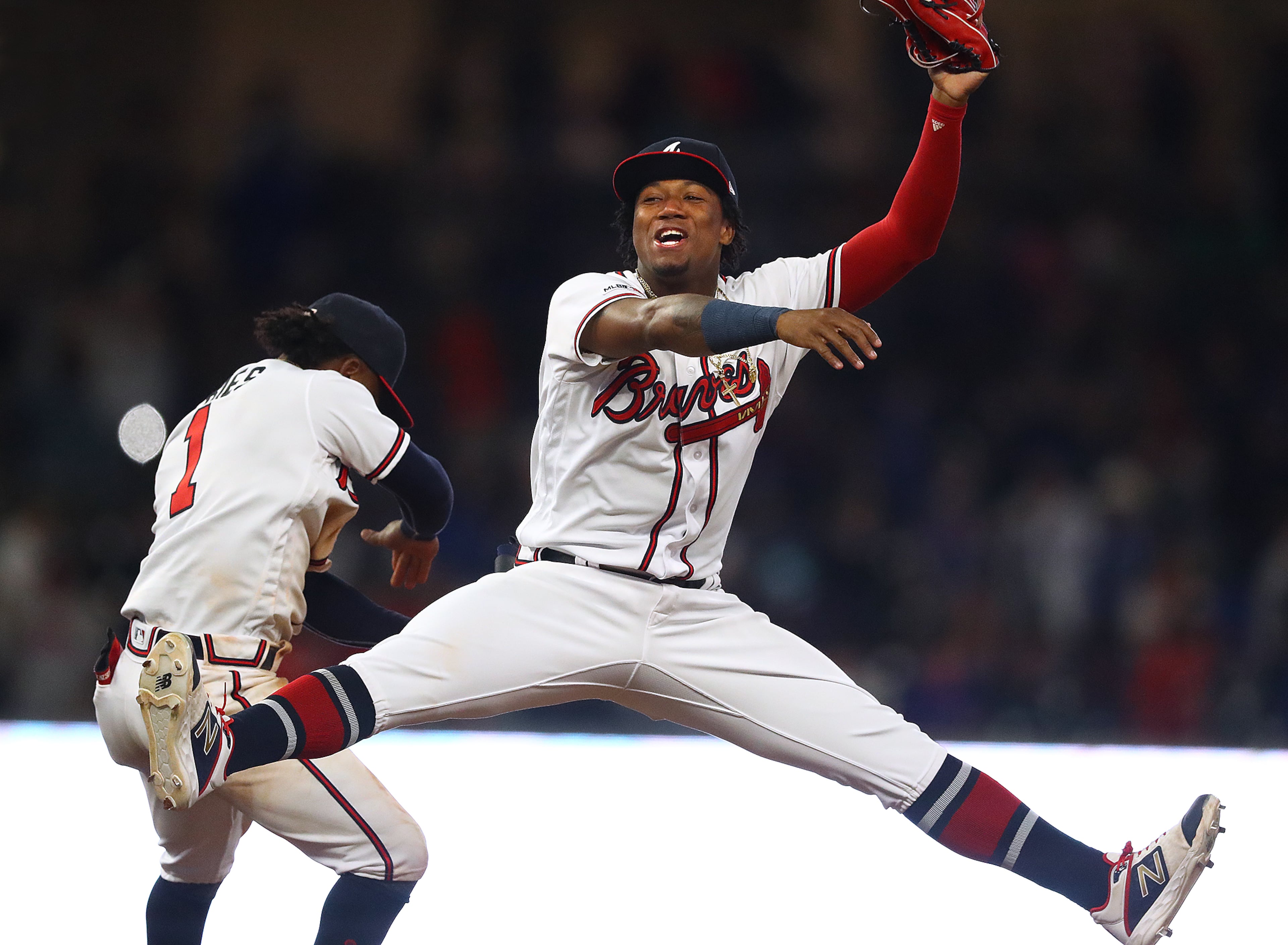 The Braves' Ronald Acuna Jr. (right), who just signed a $100 million contract extension with the Braves, and Ozzie Albies celebrate a 6-4 victory over the Chicago Cubs on Wednesday, April 3, 2019, in Atlanta. Curtis Compton/ccompton@ajc.com