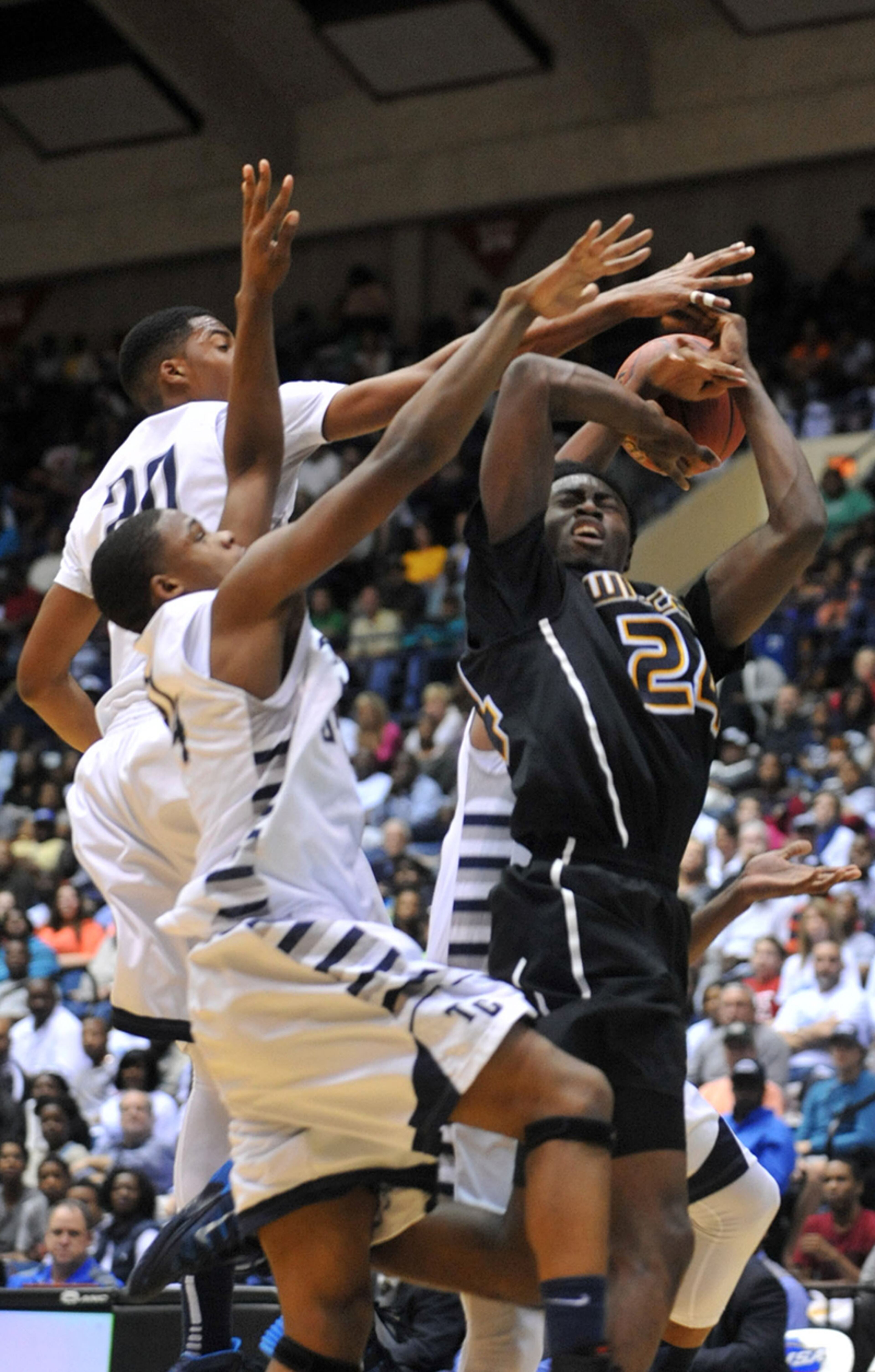 Wheeler's Jaylen Brown (24) is fouled as he goes up for a shot. The Blue Devils won the Class AAAAAA over the Wildcats, 63-49, Saturday, March 8, 2014, in Macon.