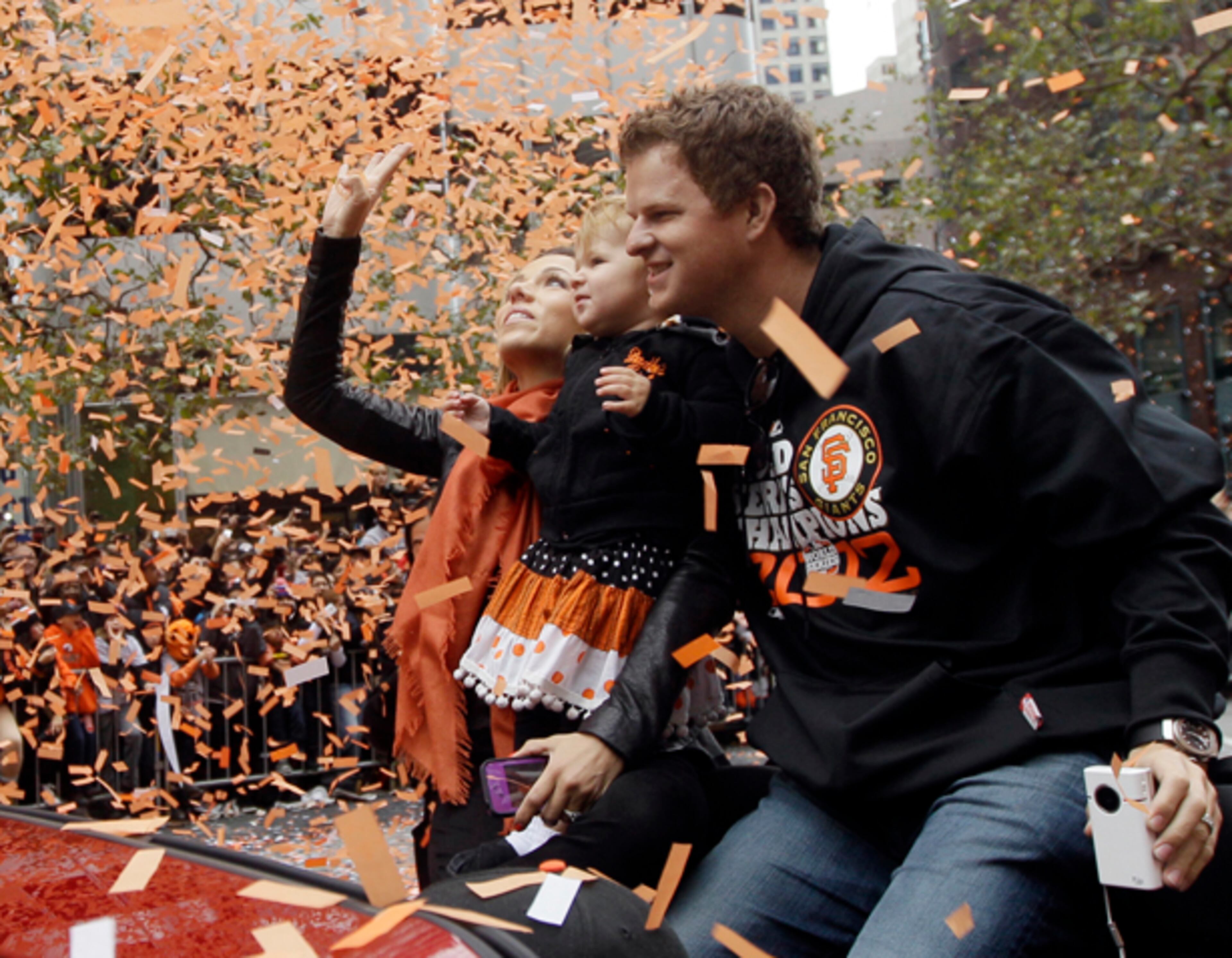 San Francisco Giants pitcher Matt Cain, his wife Chelsea, and daughter Hartley ride in a car as confetti falls during the San Francisco Giants World Series victory parade, Wednesday, Oct. 31, 2012, in San Francisco. (AP Photo/Jeff Chiu)