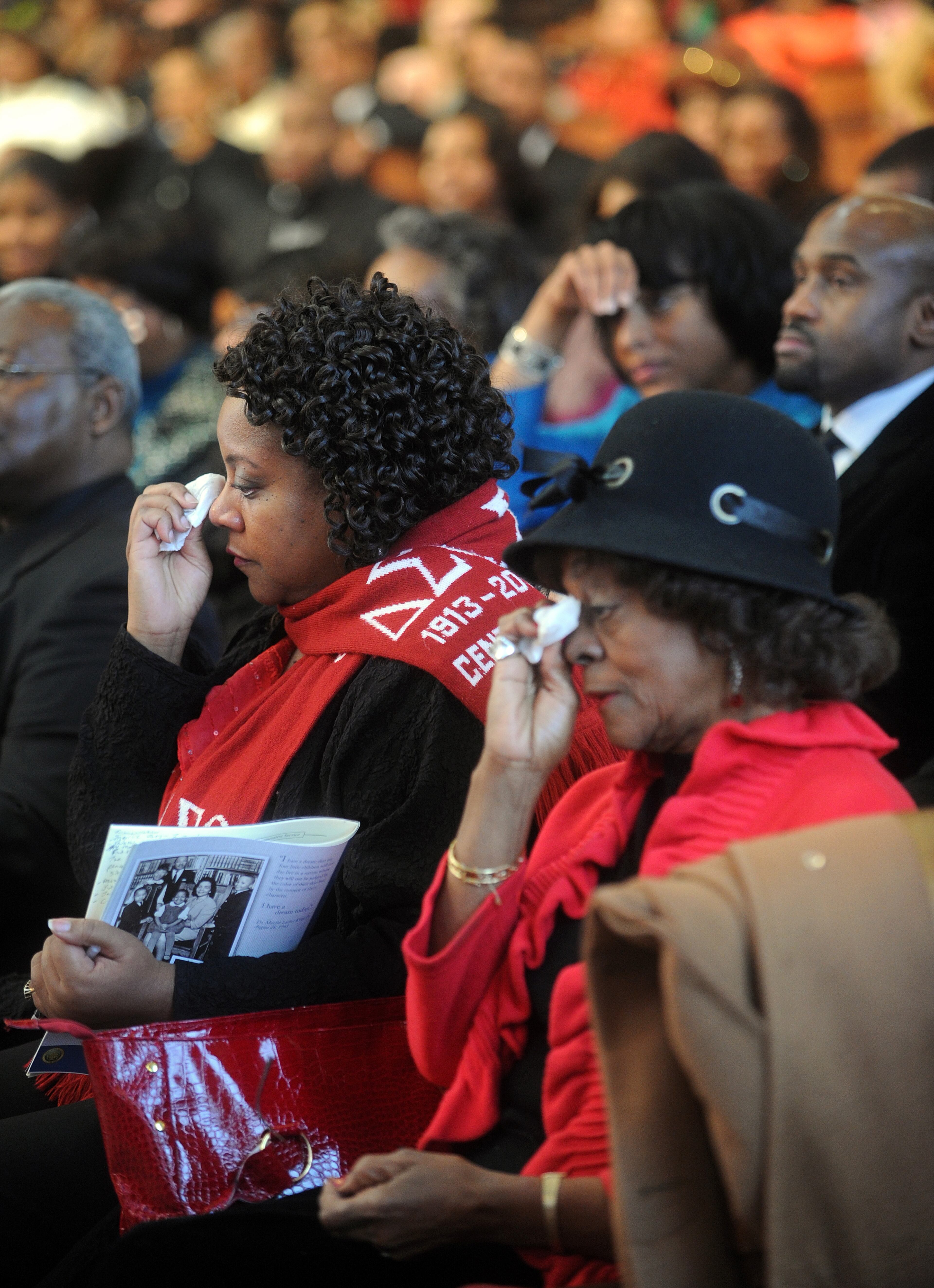 (From left) Herschelle Adams and her mother Ozie "Jackie" Adams each wipe tears from their eyes as they watch a broadcast of President Barack Obama's inauguration after the Martin Luther King, Jr. Annual Commemorative Service at Ebenezer Baptist Church in Atlanta Monday, Jan. 21, 2013.
