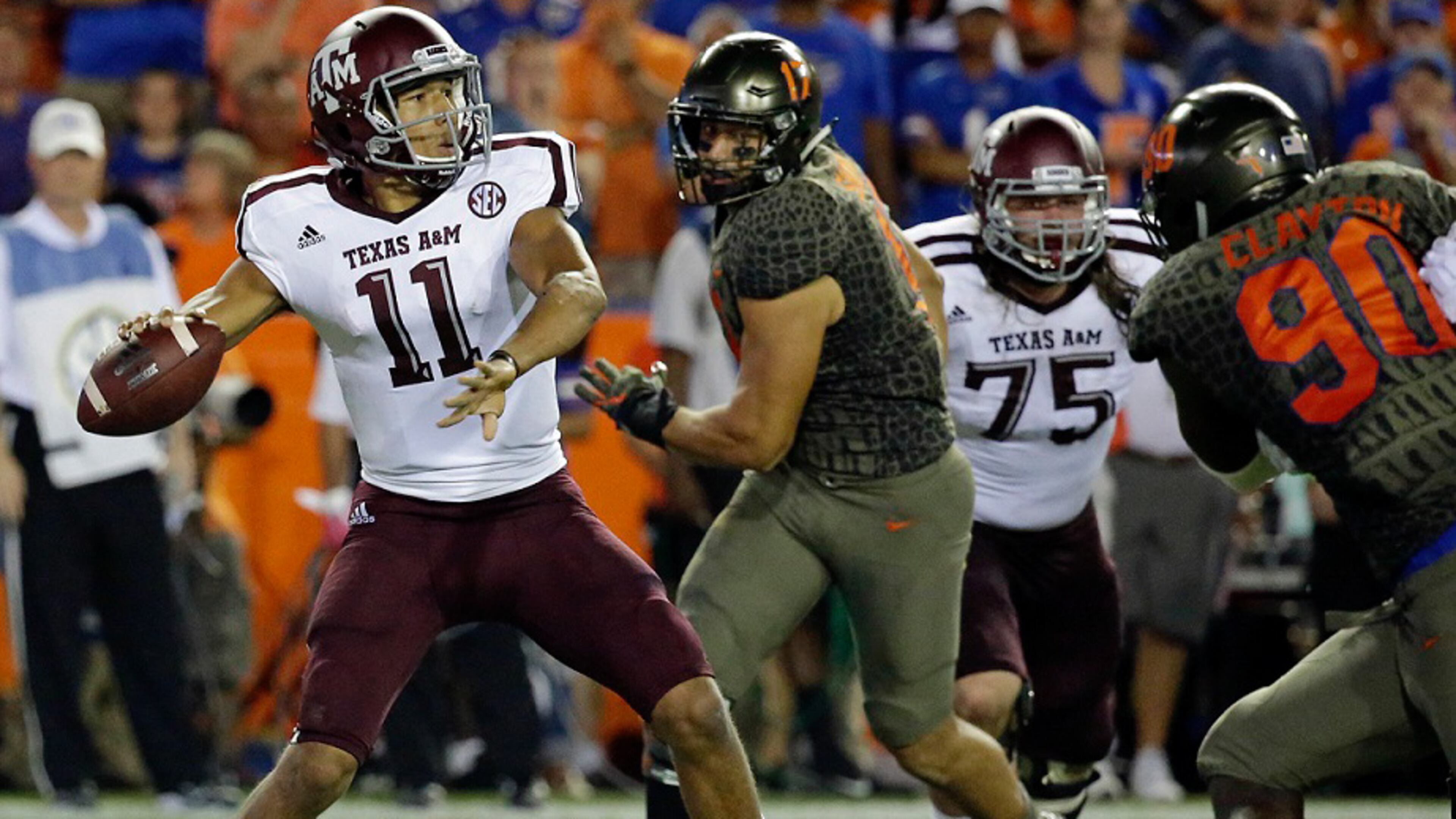 Texas A&M quarterback Kellen Mond (11) throws a pass as he is pressured by Florida defensive lineman Antonneous Clayton (90) and defensive lineman Jordan Sherit (17) on Saturday, Oct. 14, 2017, in Gainesville, Fla. (AP Photo/John Raoux)
