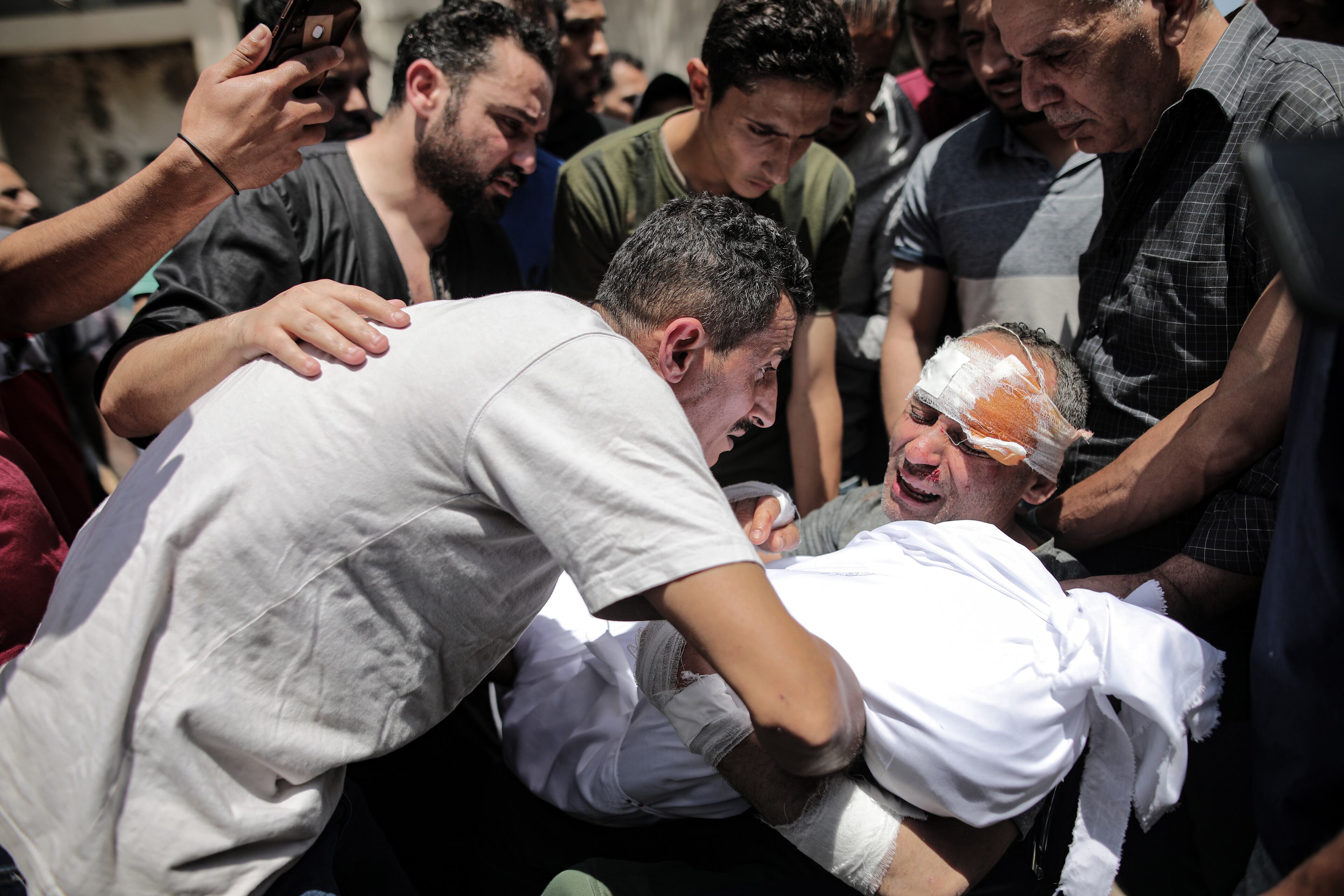 A victim of an Israeli airstrike mourns the loss of family members in Gaza City, Gaza Strip, May 16, 2021. The Israeli bombing in Gaza City killed at least 33 people, including 12 women and eight children, and wounded 50 others, according to Palestinian health authorities. They said the toll was likely to climb as rescuers picked through the rubble searching for victims and survivors. (Hosam Salem/The New York Times)