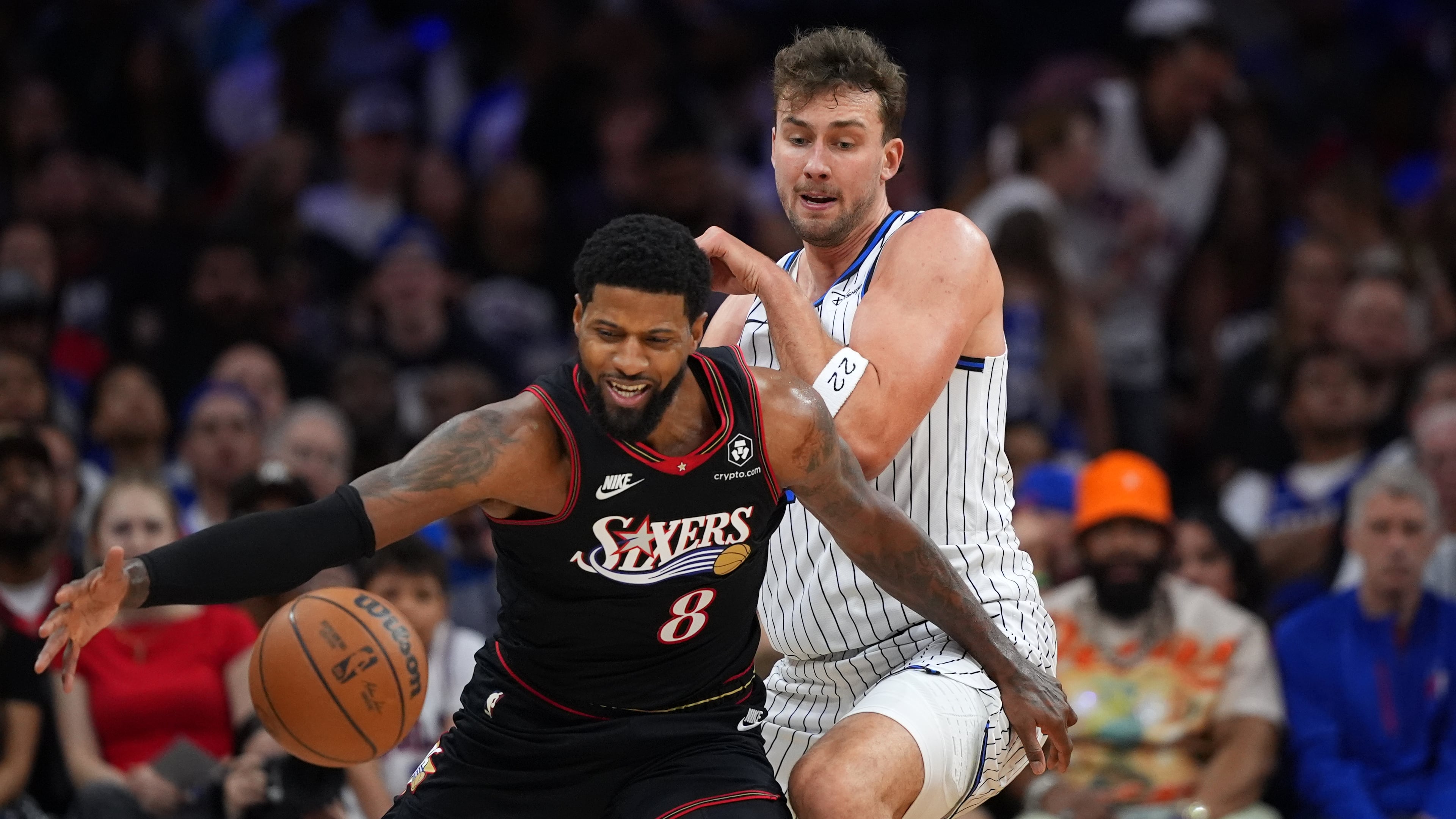 Philadelphia 76ers' Paul George, left, tries to get past Orlando Magic's Franz Wagner during the first half of an NBA play-in tournament basketball game Wednesday, April 15, 2026, in Philadelphia. (AP Photo/Matt Slocum)