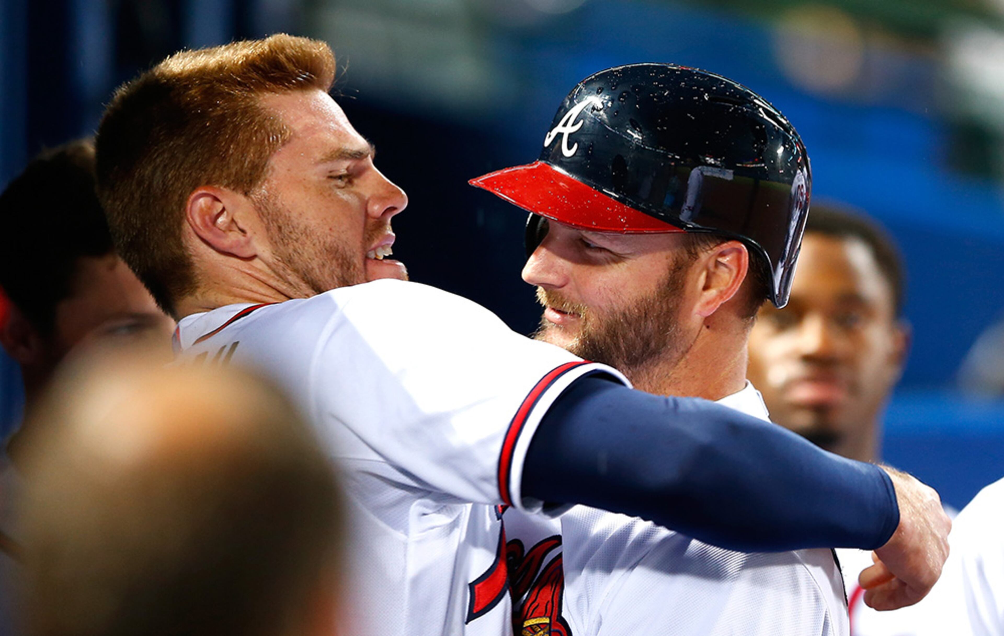 Freddie Freeman #5 of the Atlanta Braves hugs A.J. Pierzynski #15 after his solo homer in the fourth inning against the Miami Marlins at Turner Field on April 14, 2015 in Atlanta, Georgia. Freeman hit a solo homer just before Pierzynski's homer.