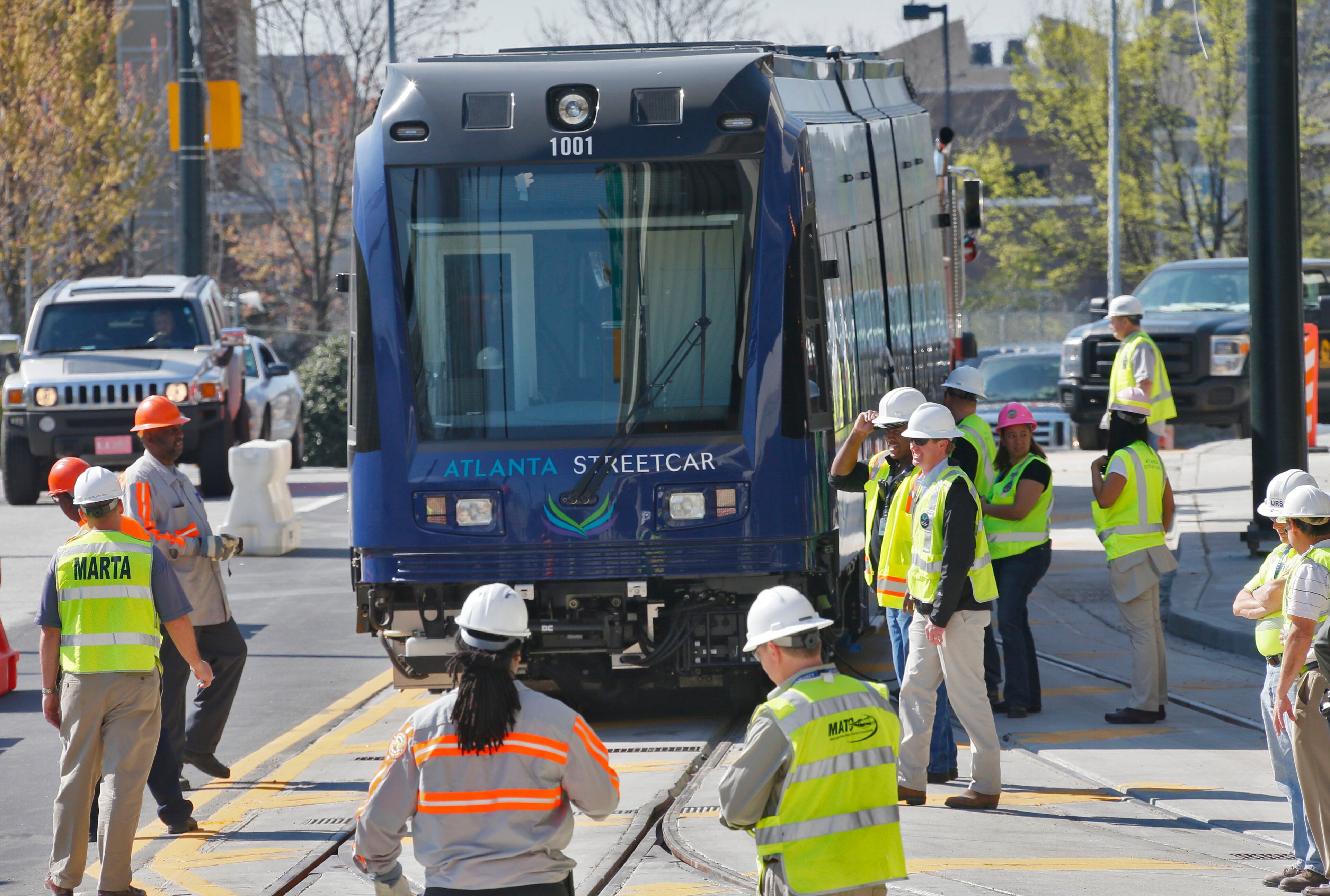 Workers used the slope of the street to roll the streetcar down to Auburn Avenue after pulling it out with a tow truck.