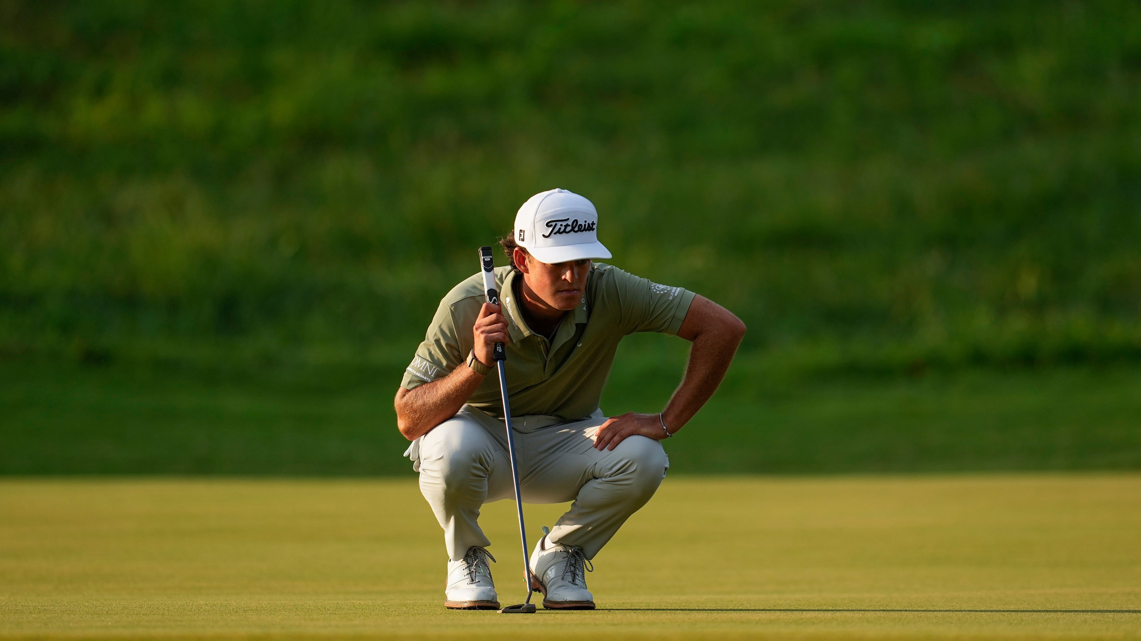 Jackson Koivun lines up his ball on the first green during the first round of the St. Jude Championship golf tournament, Thursday, Aug. 13, 2026, in Memphis, Tenn. (AP Photo/George Walker IV)