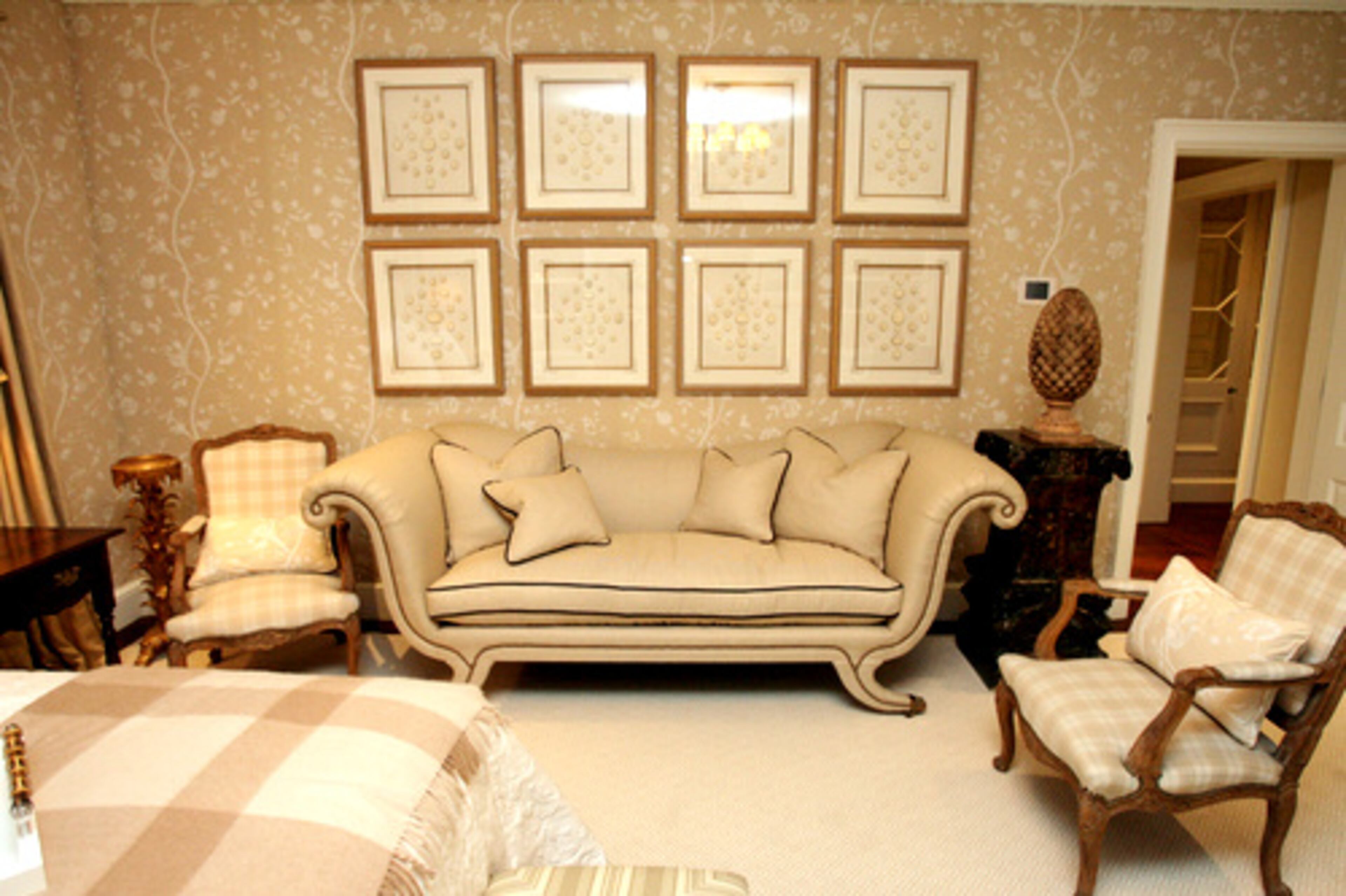 Carithers used an upholstered sofa from his collection by Sherrill Furniture in the master suite. The tan and cream houndstooth pattern is by Schumacher.