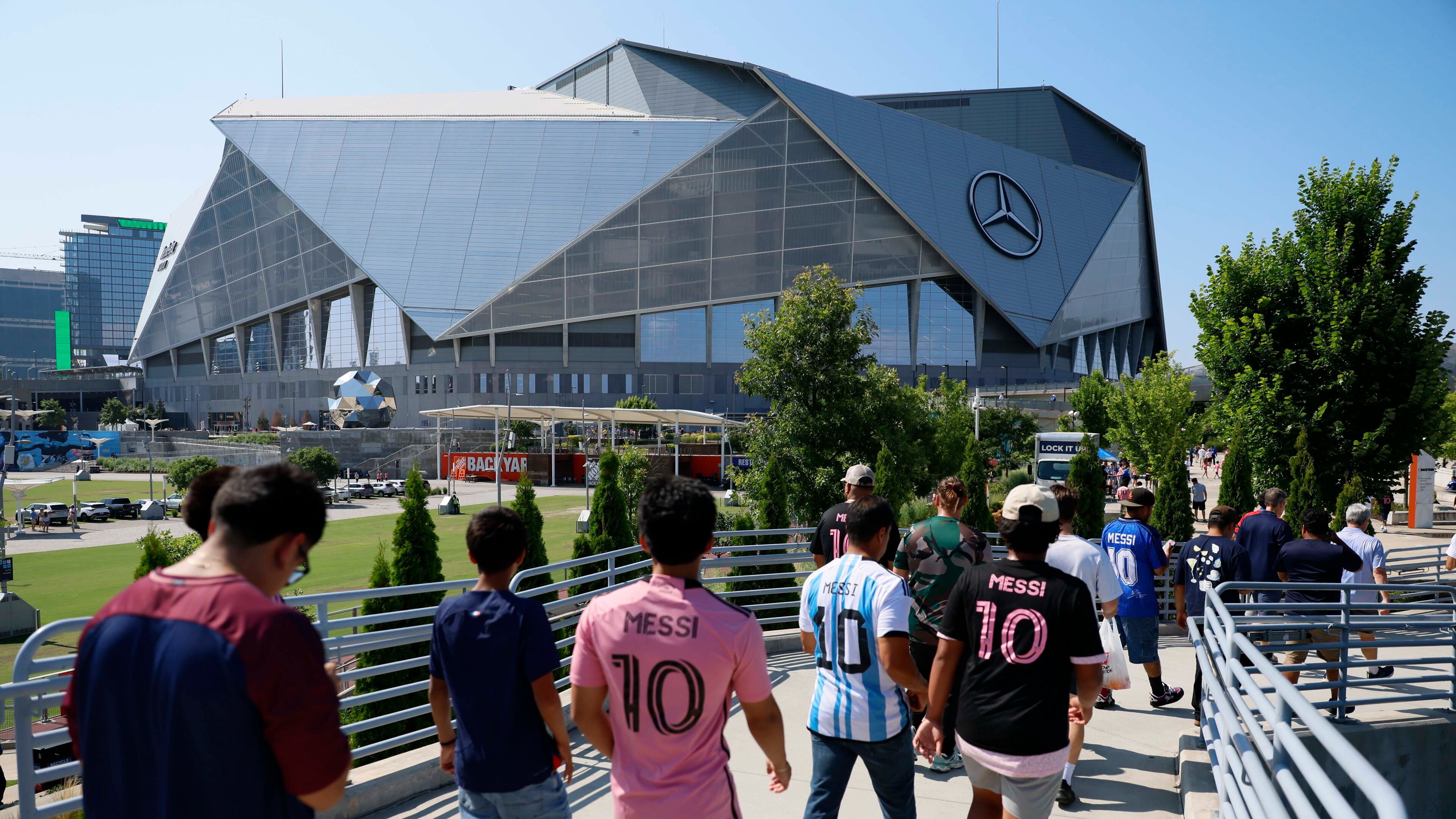 Fans walk toward the Mercedes-Benz Stadium before the round of 16 soccer match between Paris Saint-Germain FC and Inter Miami in Atlanta, Georgia, on Sunday, June 29, 2025. (Miguel Martinez/AJC)