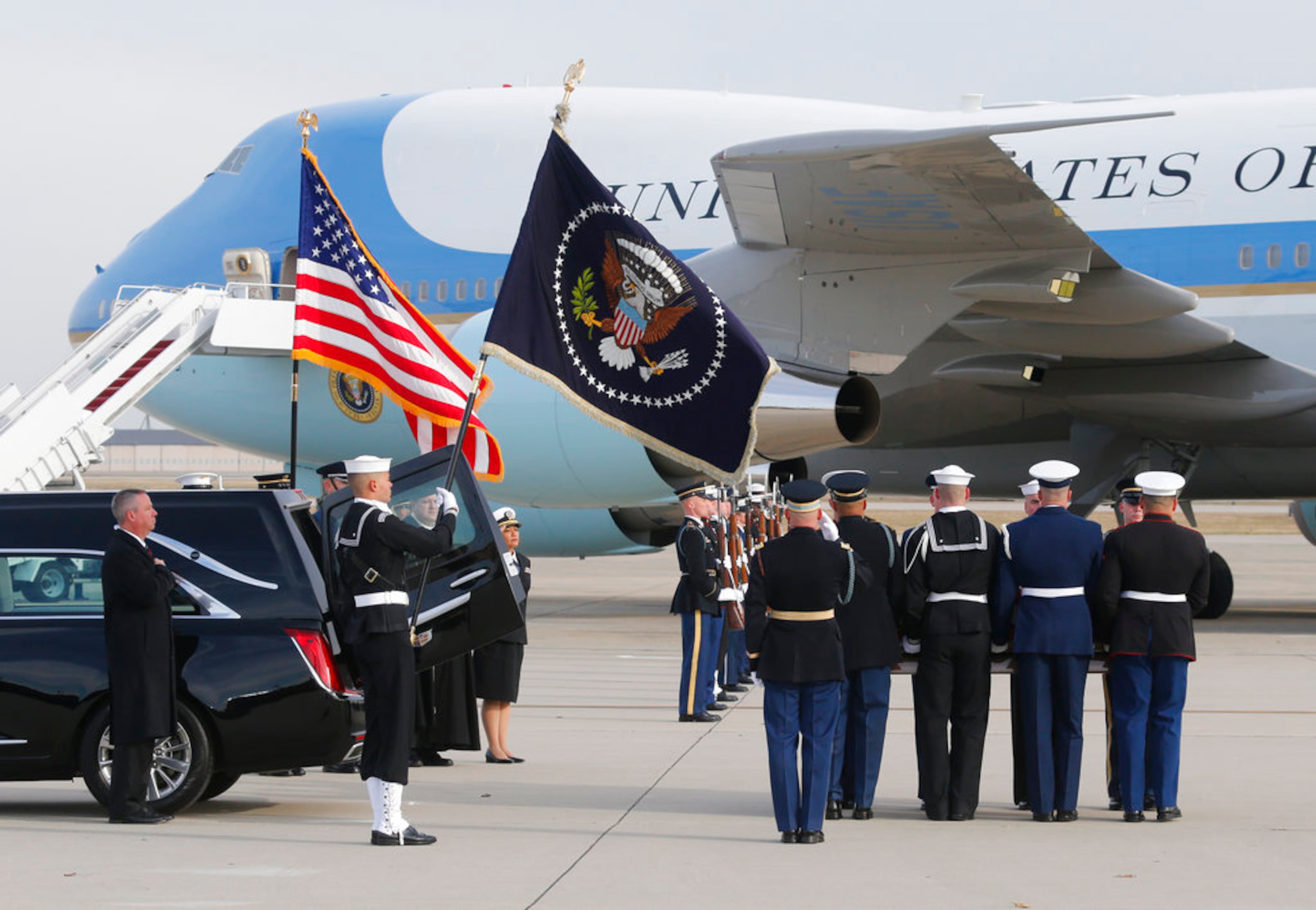 The flag-draped casket of former President George H.W. Bush is carried by a joint services military honor guard during a departure ceremony at Andrews Air Force Base, Md., Wednesday, Nov. 5, 2018. (AP Photo/Steve Helber)