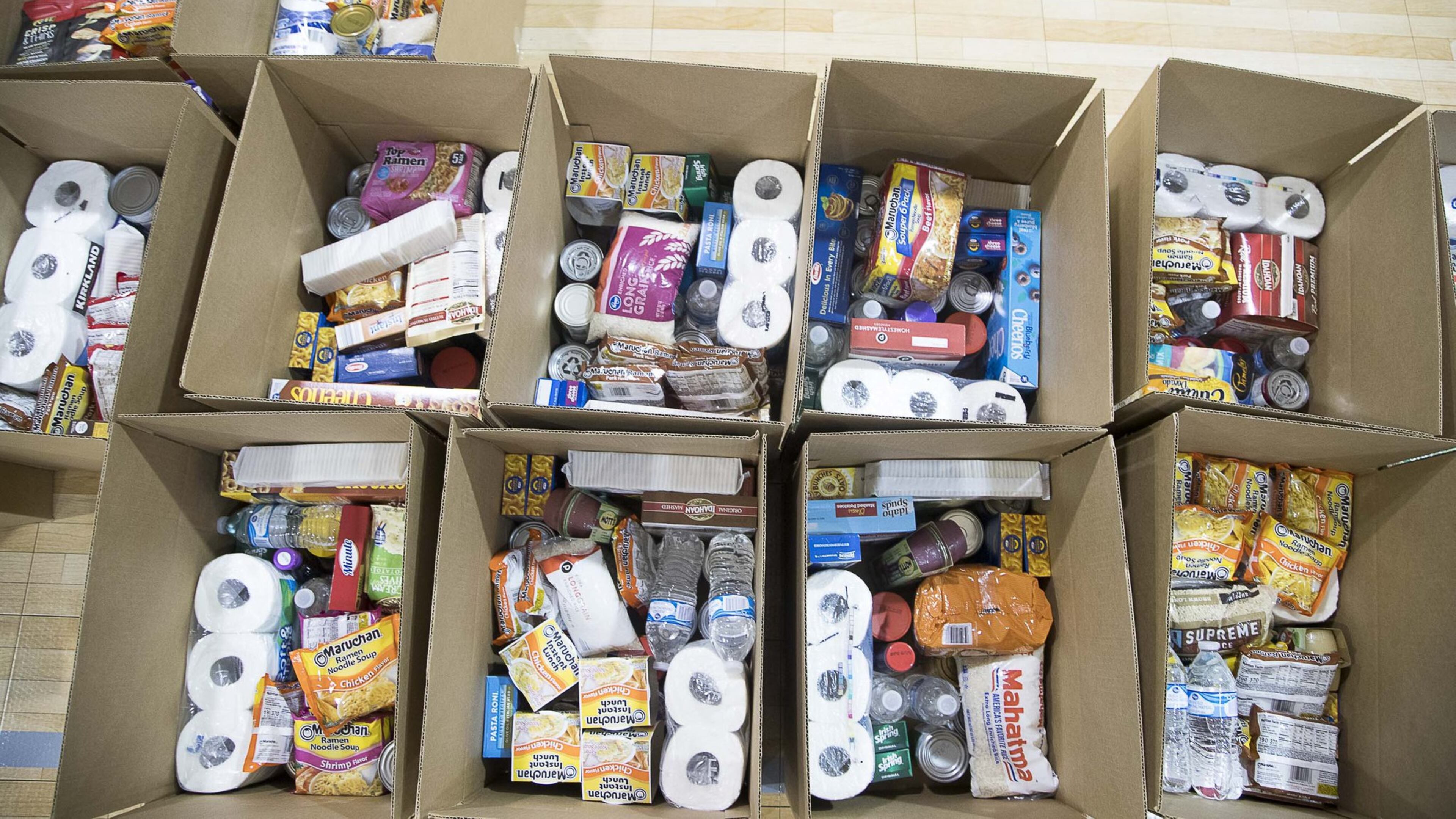 Boxes of food and toiletry items are ready for distribution during an Atlanta Community Food Bank and Fulton County Schools collaborative distribution at Elizabeth Baptist Church in Atlanta. ALYSSA POINTER / ALYSSA.POINTER@AJC.COM