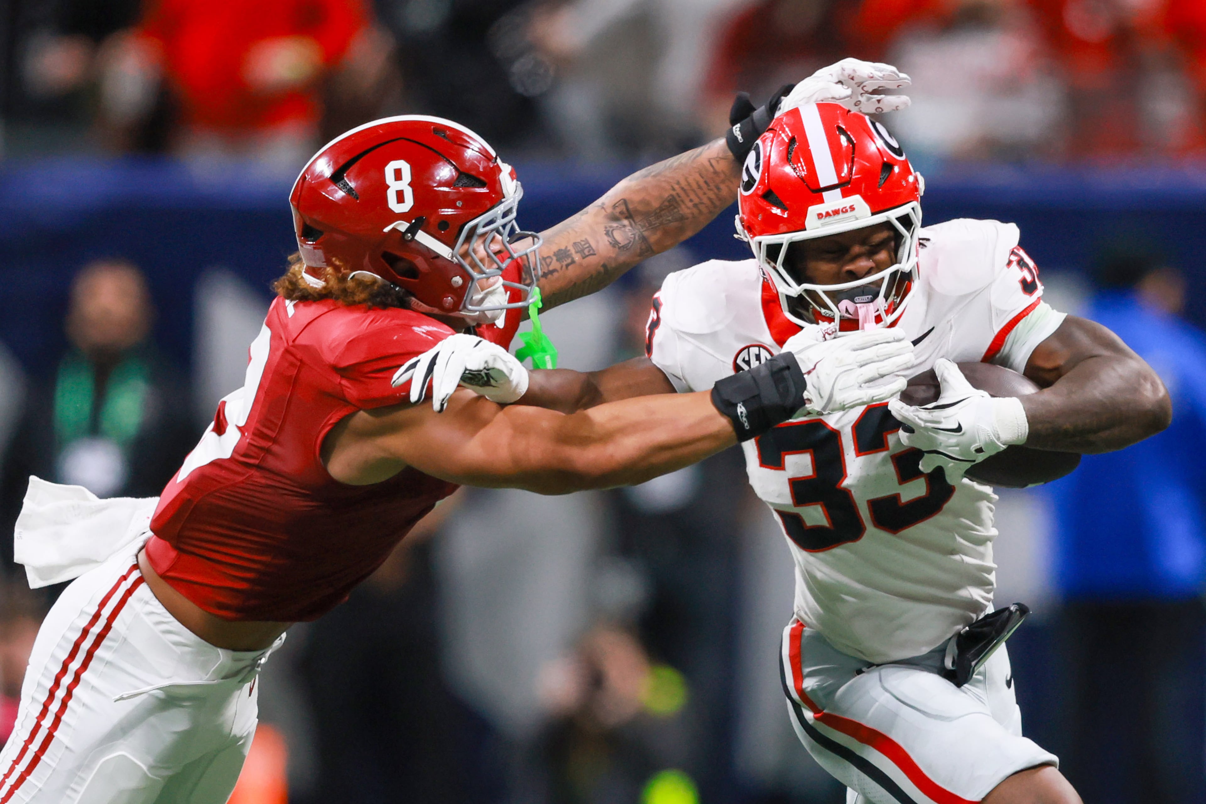 Georgia running back Chauncey Bowens (33) runs against Alabama linebacker Justin Hill (8) during the second quarter of the SEC Championship game at Mercedes-Benz Stadium, Saturday, Dec. 6, 2025, in Atlanta. (Jason Getz / AJC)