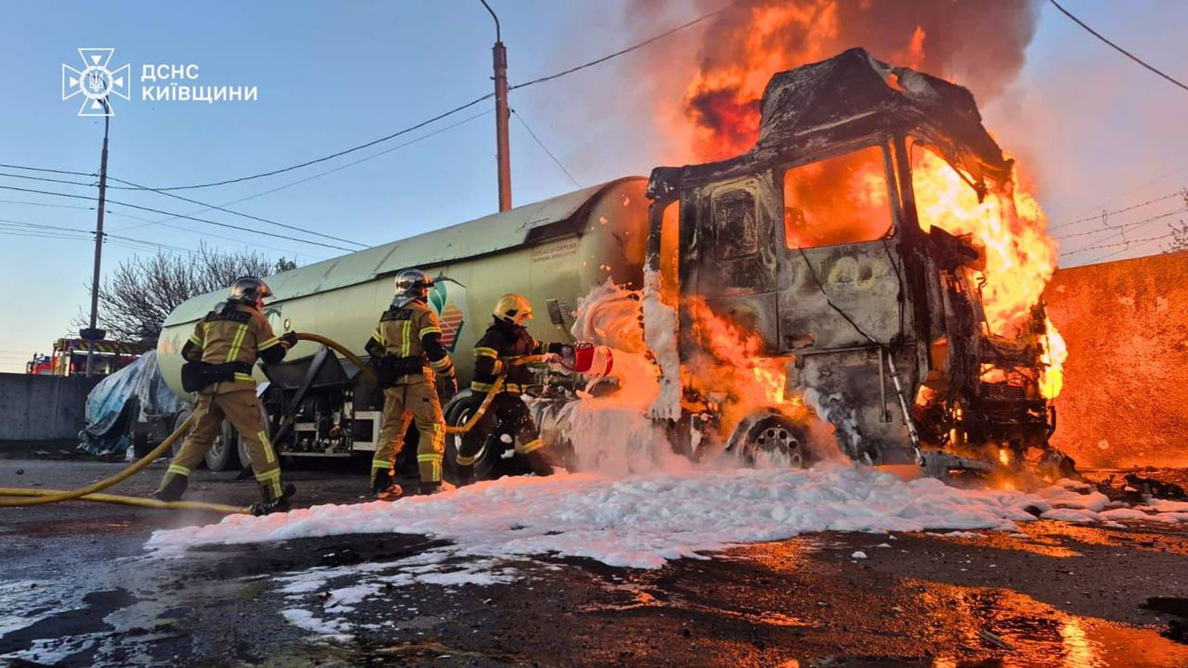 In this photo, provided by the Ukrainian Emergency Service, emergency services personnel work to extinguish a fire a vehicle following a Russian drone attack in Kyiv region, Ukraine, Tuesday, May 5, 2026. (Ukrainian Emergency Service via AP)