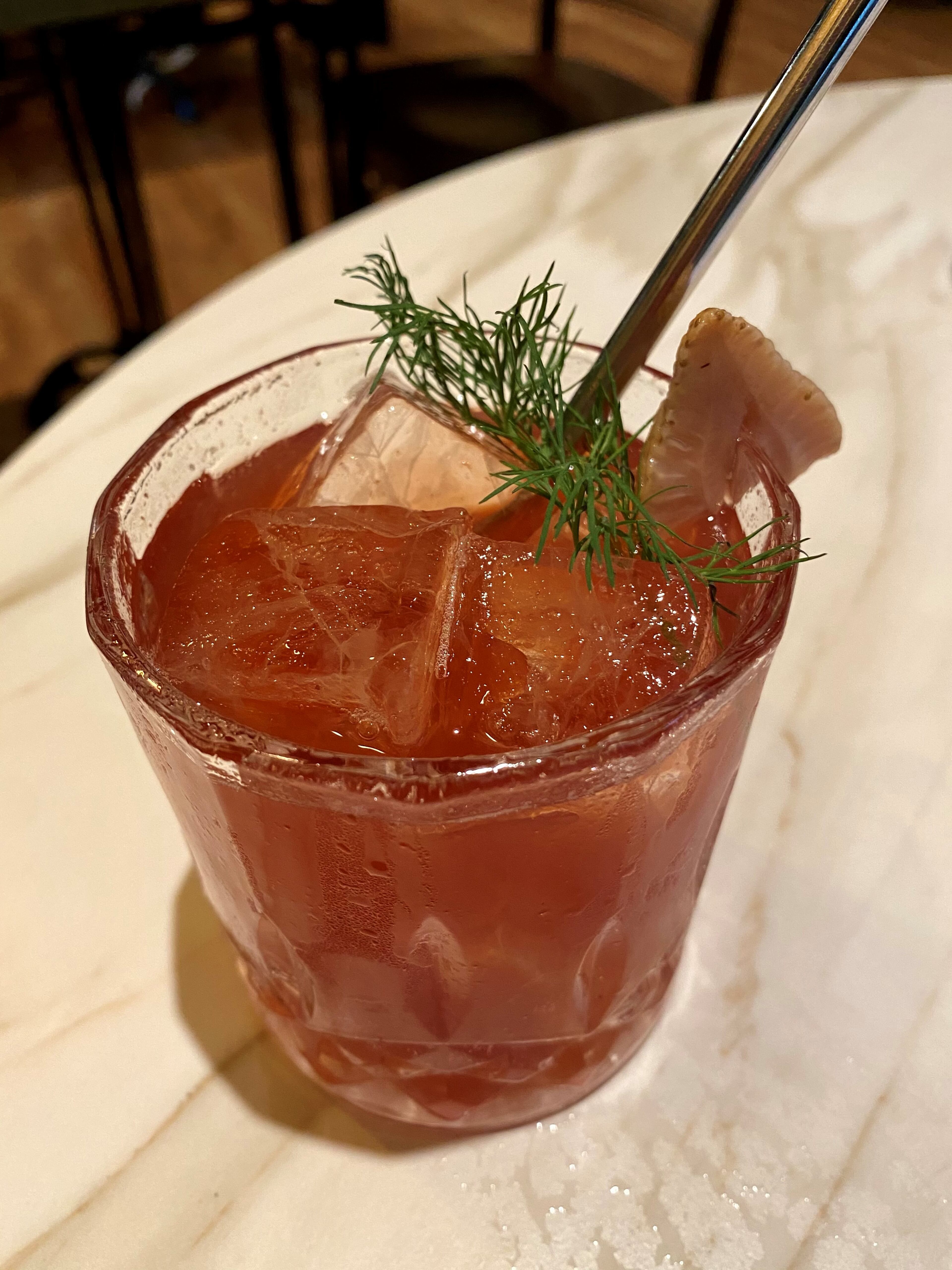 Falling Rabbit’s Green on the Vine cocktail is made with Wild Turkey rye, strawberry-dill shrub and BroVo rose vermouth, and garnished with dill and a slice of green strawberry. (Wendell Brock for The Atlanta Journal-Constitution)