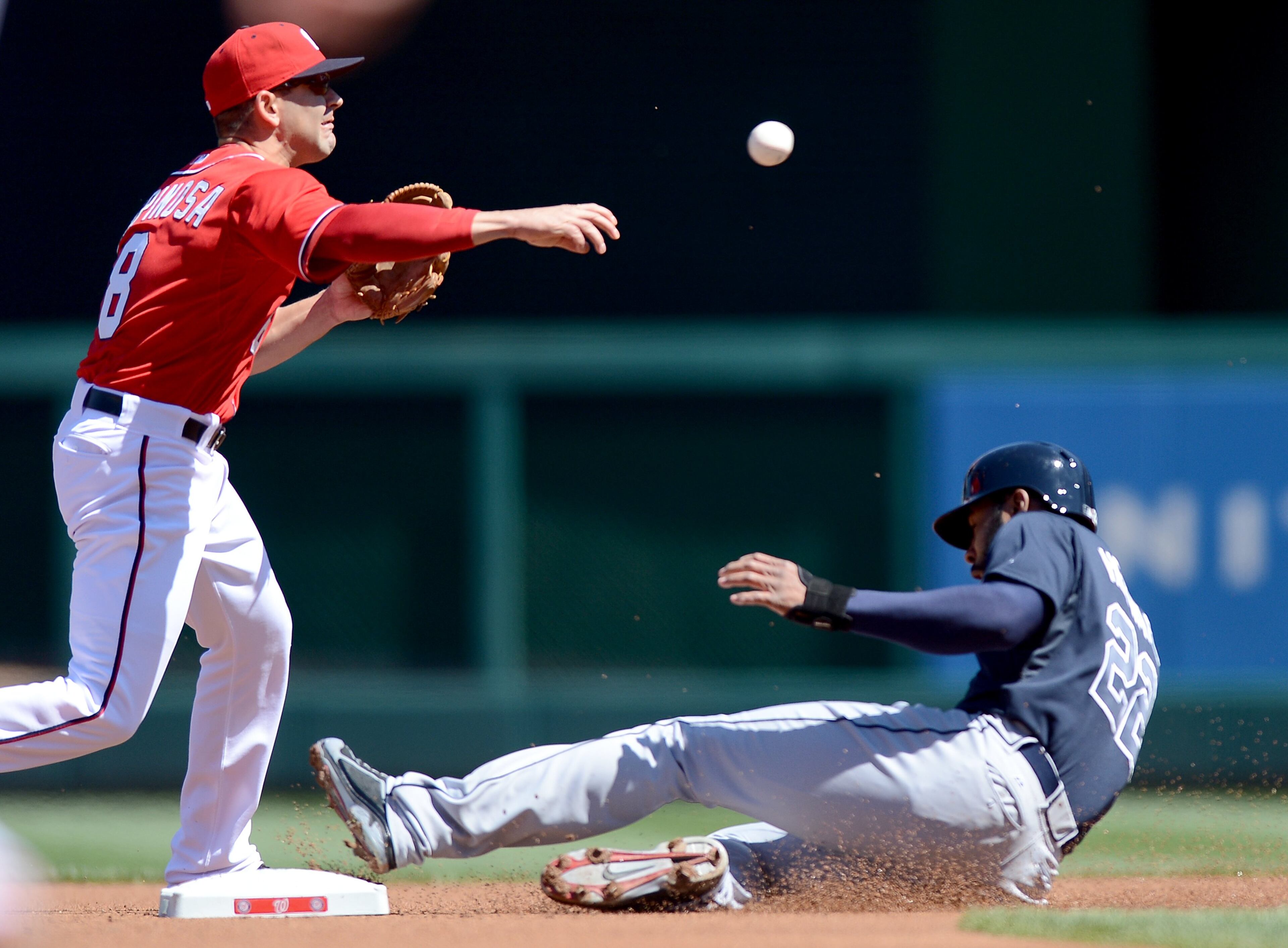 Washington Nationals second baseman Danny Espinosa (8) turns a double play over Atlanta Braves right fielder Jason Heyward (22) in the first inning at Nationals Park in Washington, D.C., Sunday, April 6, 2014. (Chuck Myers/MCT)